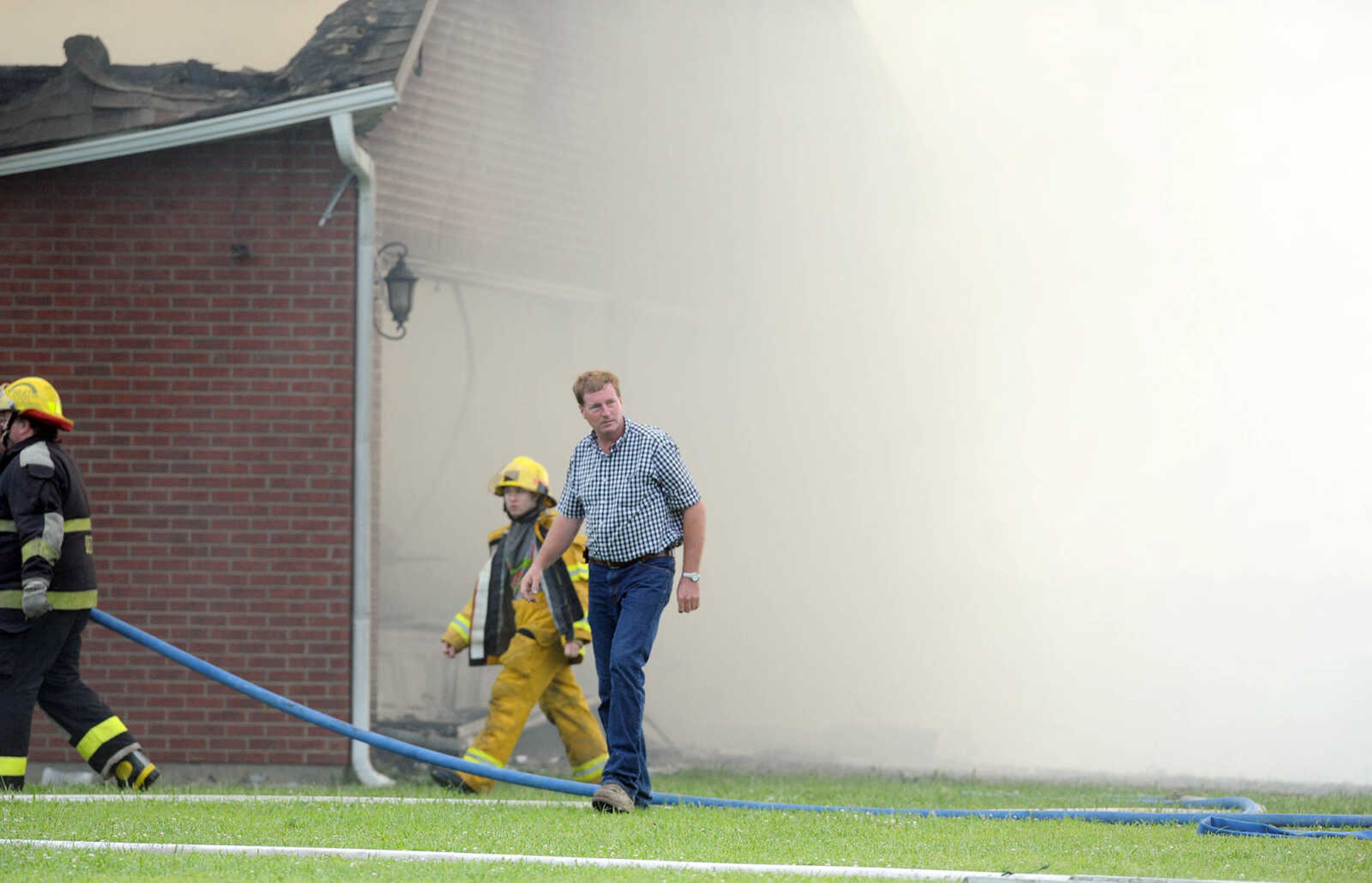 LAURA SIMON ~ lsimon@semissourian.com

David Landewee circles the perimeter of his house as firefighters from Delta, Scott City, Chaffee and New Hamburg/Benton/Commerce battle the fire engulfing his house off County Road 204 in Scott County Wednesday afternoon, July 23, 2014.