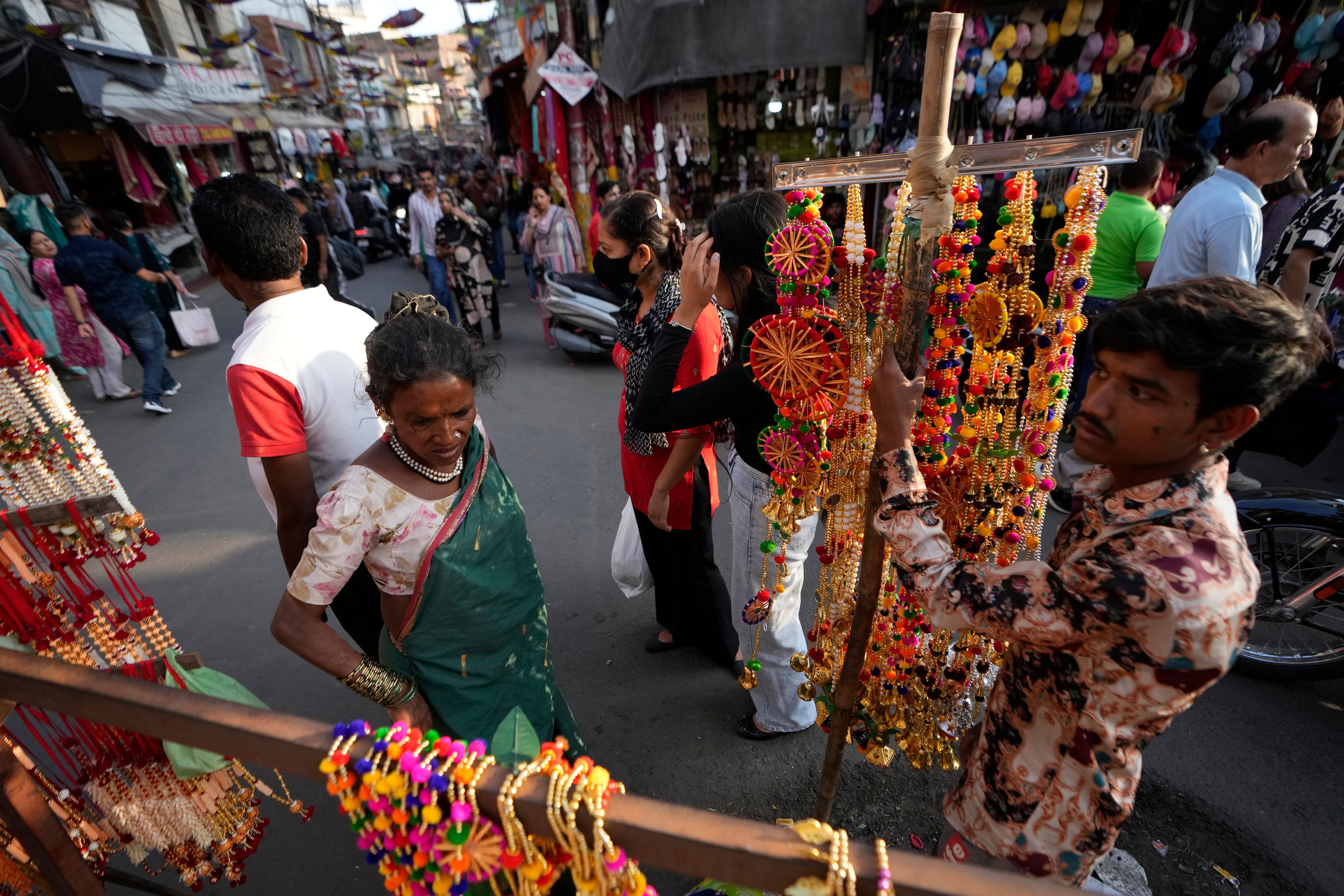 Vendor display artificial decorative flowers and wait for customers on the eve of the Diwali festival in Jammu, India, Wednesday, Oct.30,2024. Diwali is one of Hinduism's most important festivals, dedicated to the worship of the goddess of wealth Lakshmi. (AP Photo/Channi Anand)