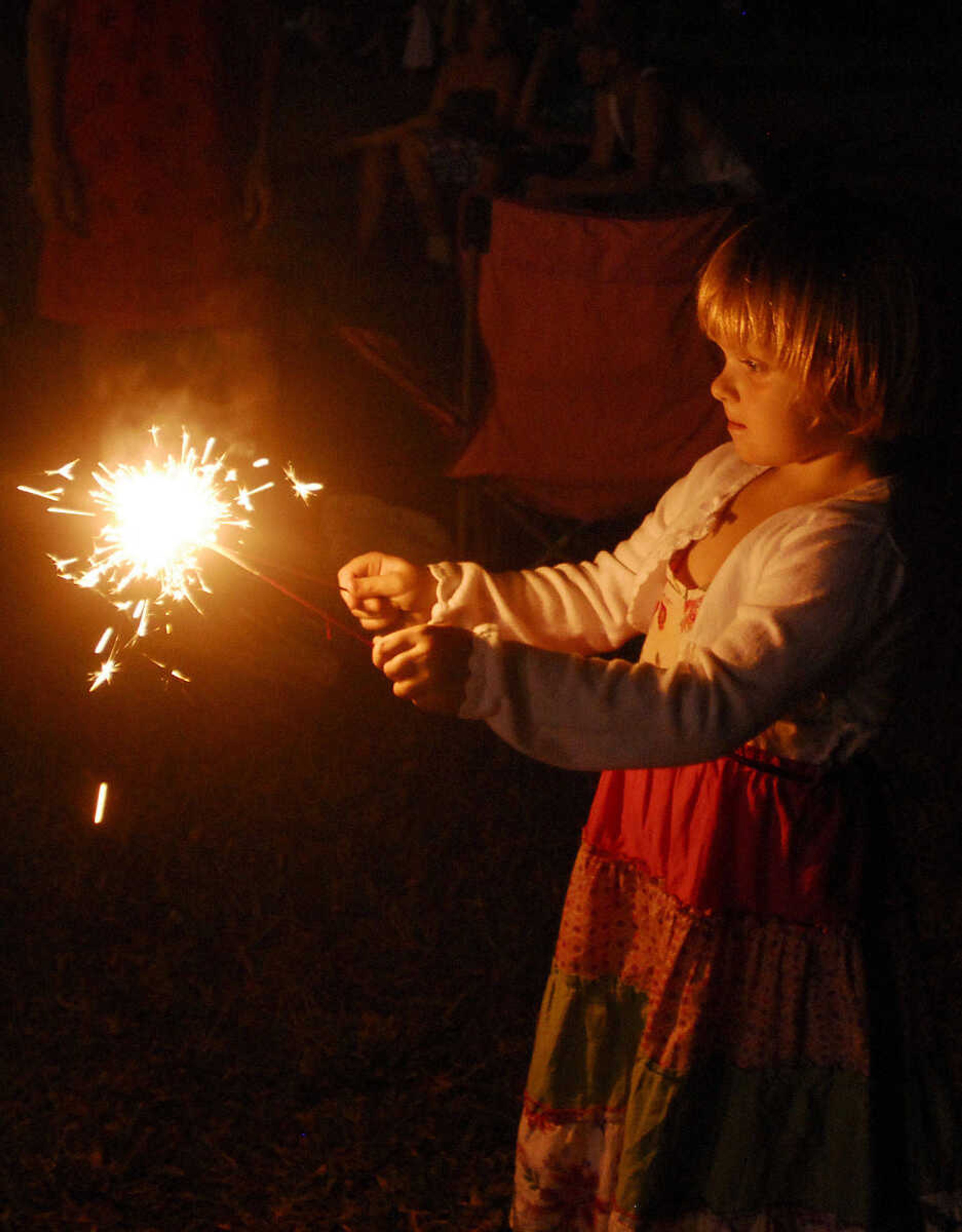 LAURA SIMON~lsimon@semissourian.com
Four-year-old Laila Benson lights her sparklers during the U.S.A. Veterans Fourth of July celebration at Arena Park in Cape Girardeau Sunday, July 4, 2010.