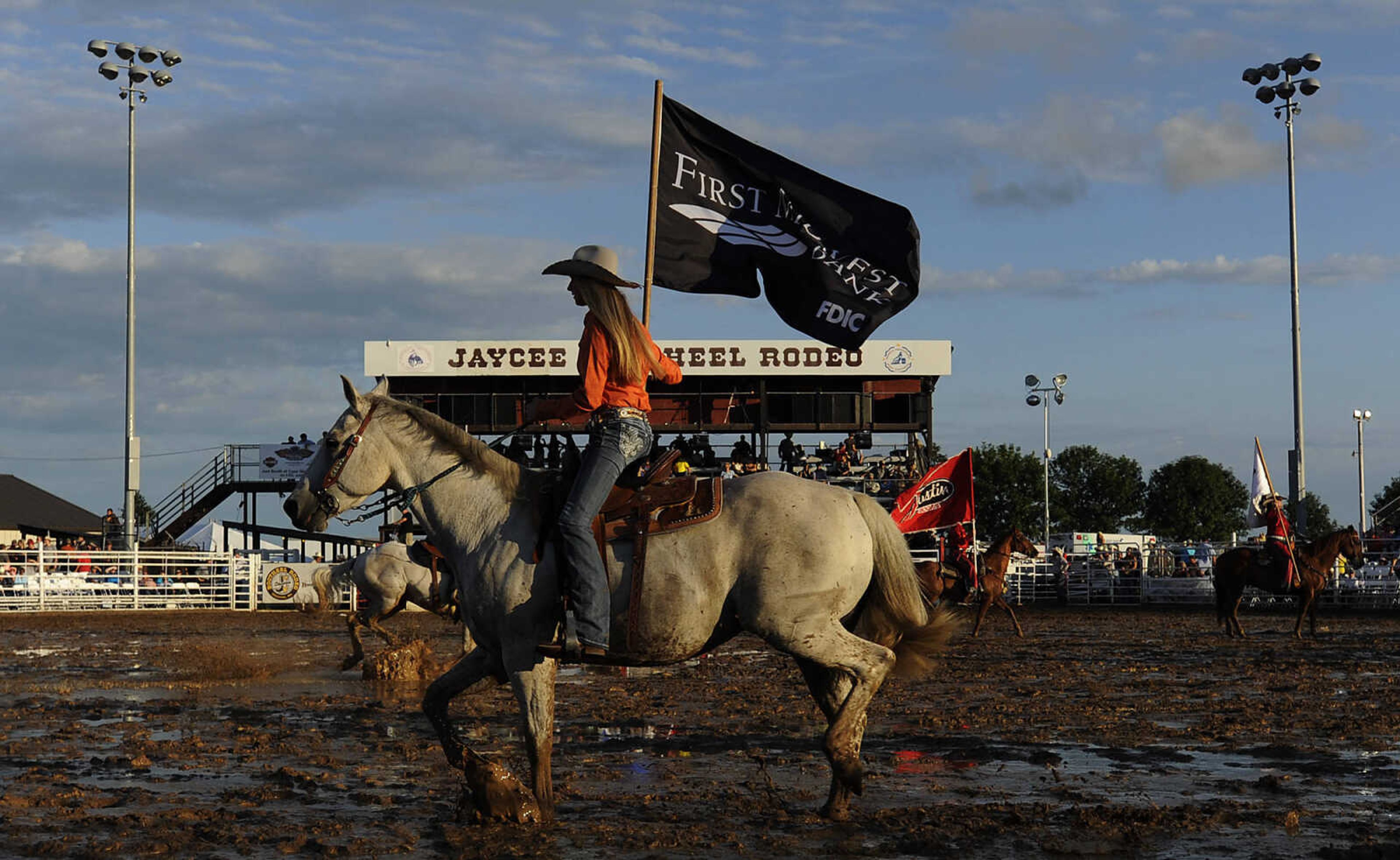 The Grand Entry circles the arena at the start of the Sikeston Jaycee Bootheel Rodeo Wednesday, August 7, in Sikeston, Mo.