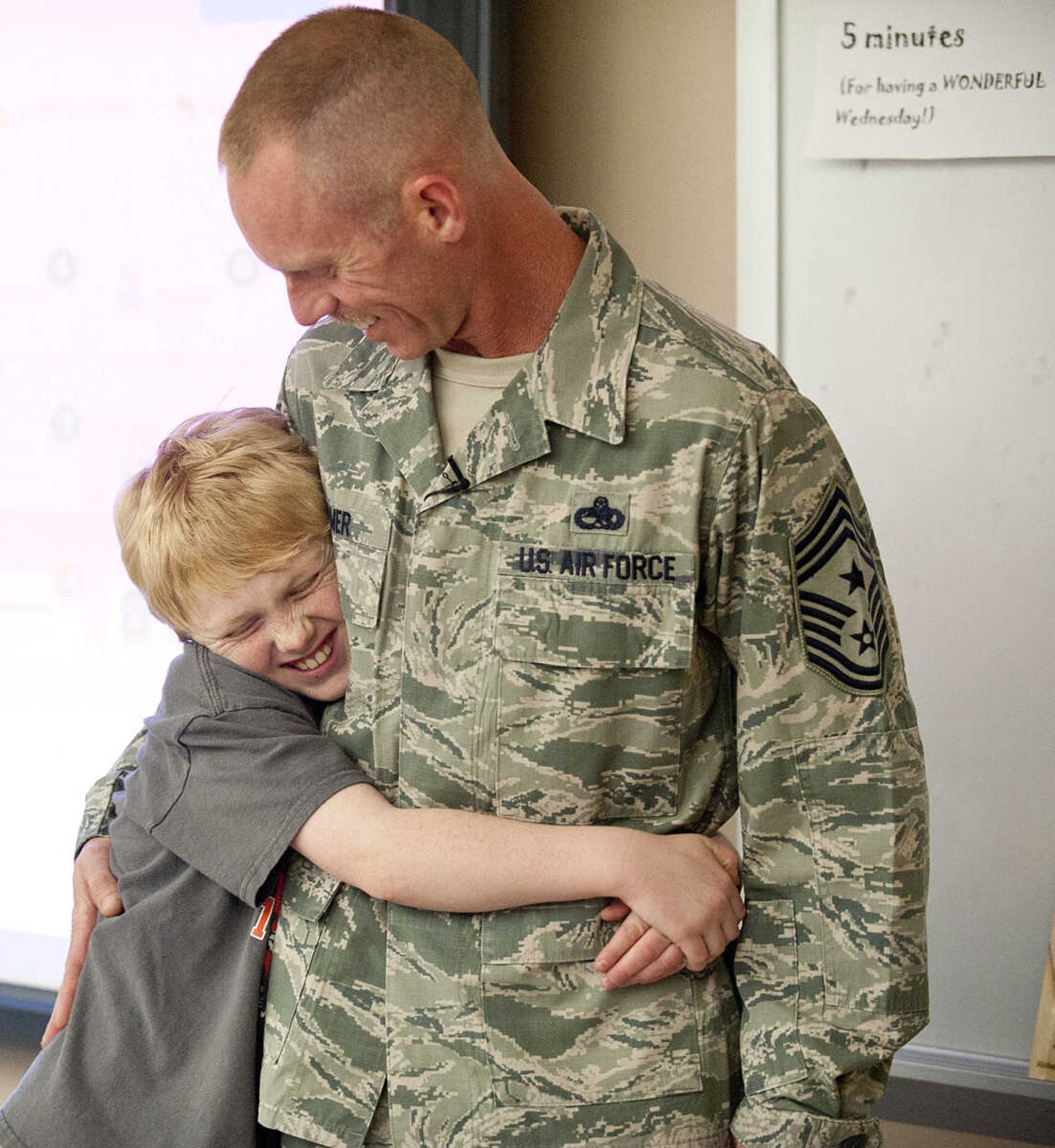 Eli Weimer, 9, hugs his father, Command Chief Master Sgt. Geoff Weimer after Geoff surprised him 
Friday, March 14, at Franklin Elementary School in Cape Girardeau. Sgt. Weimer is on leave from the Air Force after being deployed in the Middle East since Oct., and surprised his three sons, Geordan, 11, Eli, 9, and Gabriel, 6, in their respective classes.