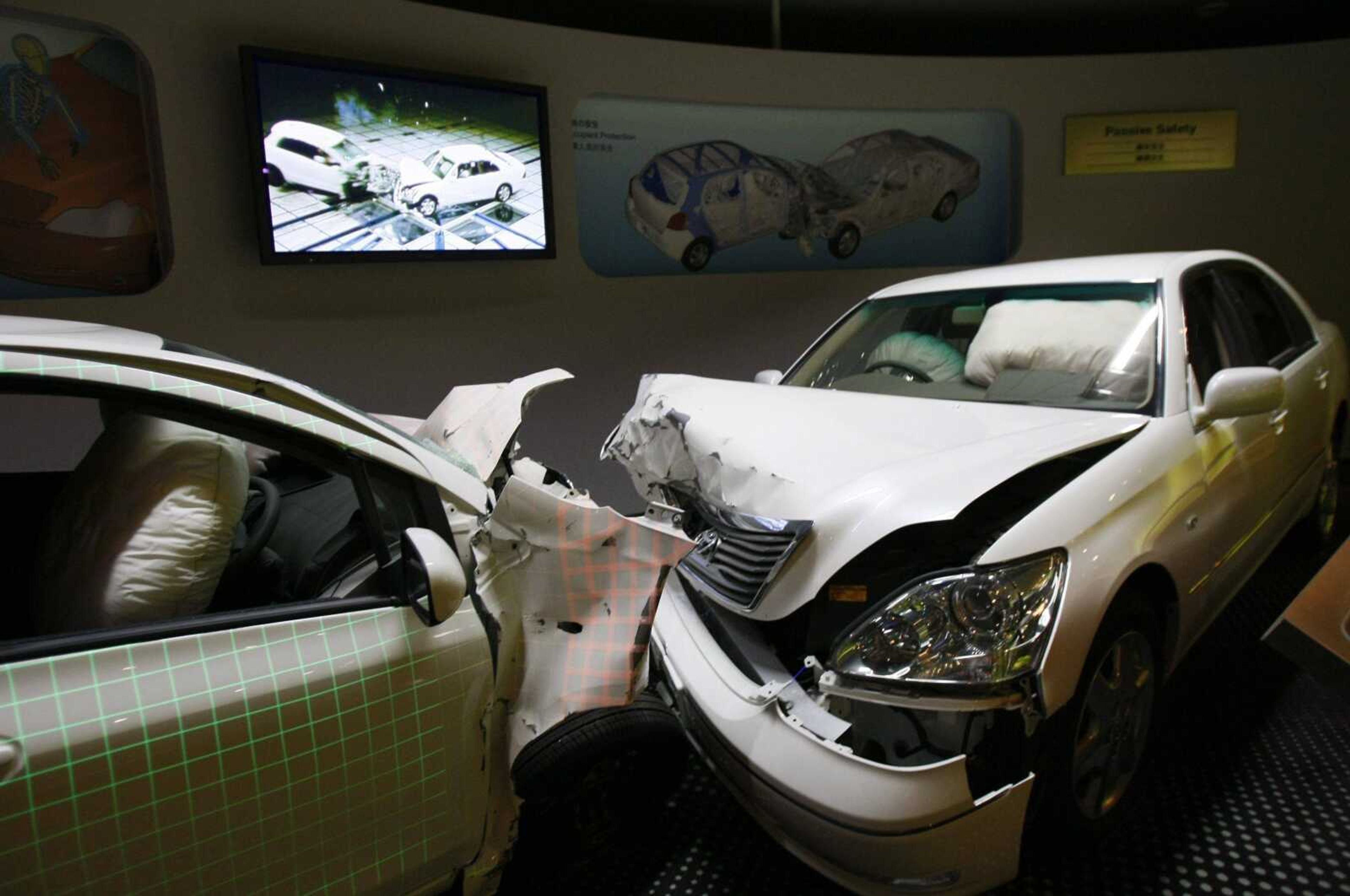 Crashed cars with airbags deployed are shown to visitors Thursday as part of the display of Toyota Motor Corp.'s safety performance standards, called "Global Outstanding Assessment," at the automaker's exhibition hall in central Japan. <br>Shuji Kajiyama <br>Associated Press