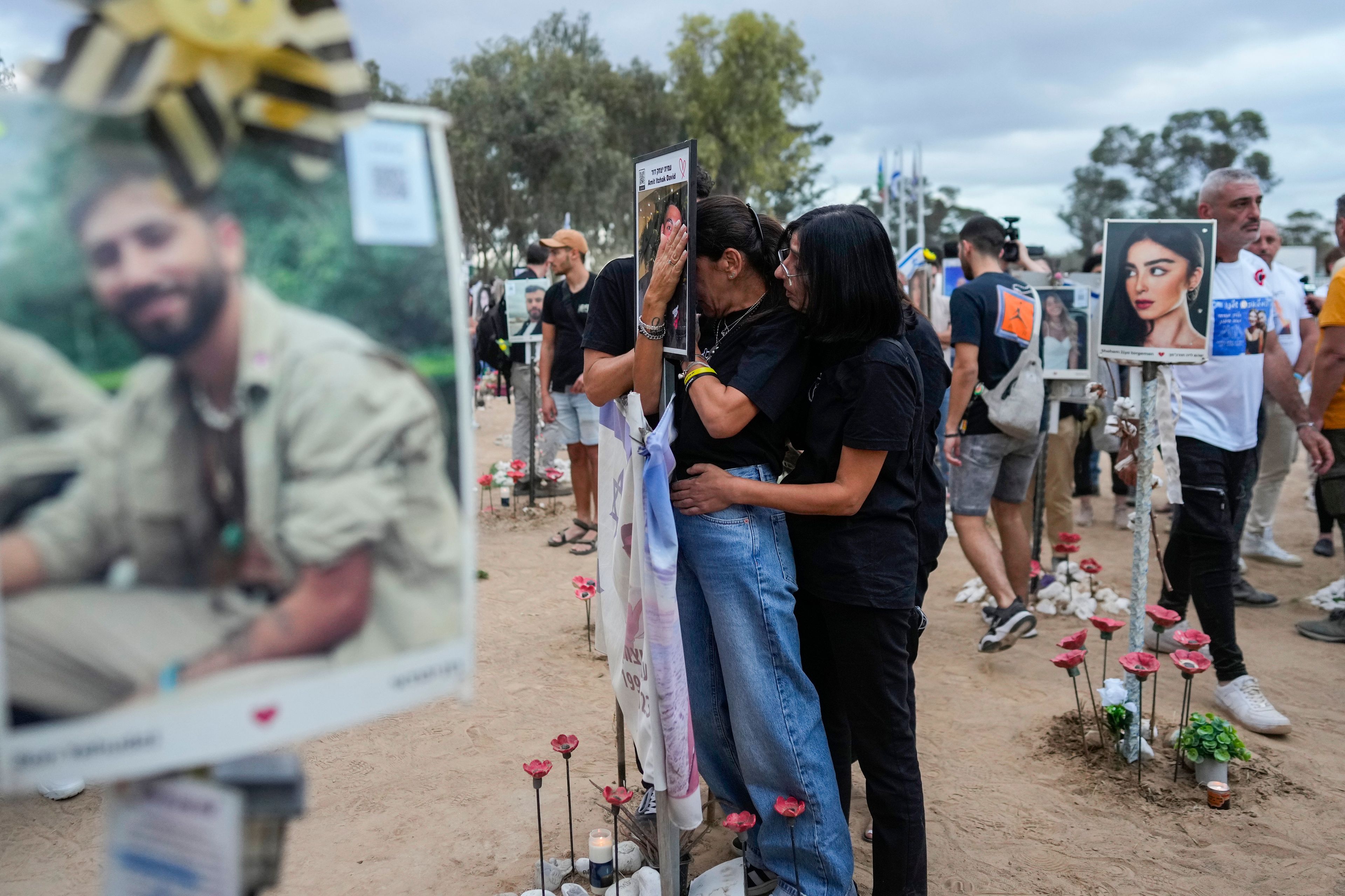 People visit the site of the Nova music festival, where hundreds of revelers were killed and abducted by Hamas and taken into Gaza, on the one-year anniversary of the attack, near Kibbutz Reim, southern Israel, Monday, Oct. 7, 2024. (AP Photo/Ohad Zwigenberg)