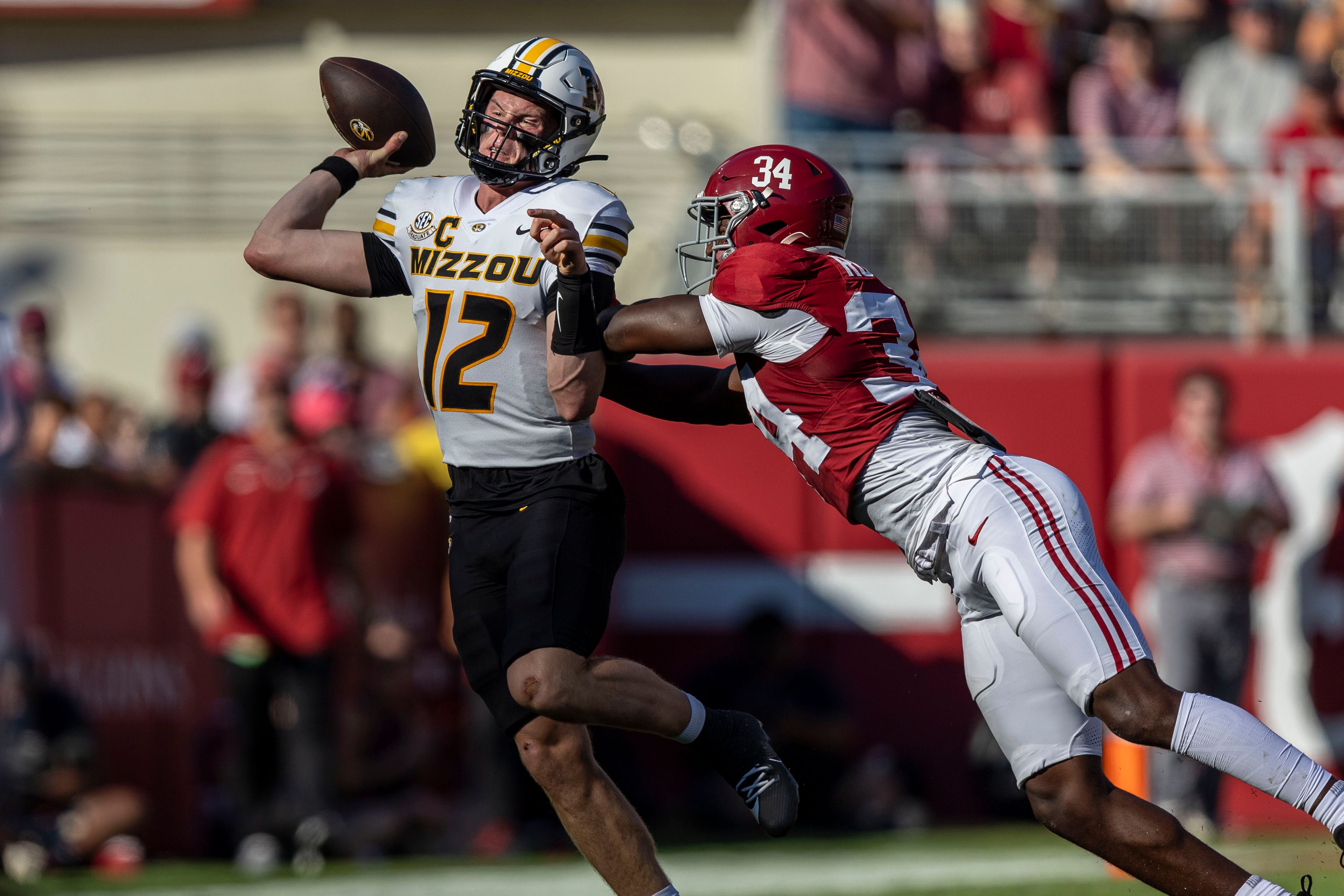 Missouri quarterback Brady Cook (12) is hit by Alabama linebacker Que Robinson (34) during the first half of an NCAA college football game, Saturday, Oct. 26, 2024, in Tuscaloosa, Ala. (AP Photo/Vasha Hunt)