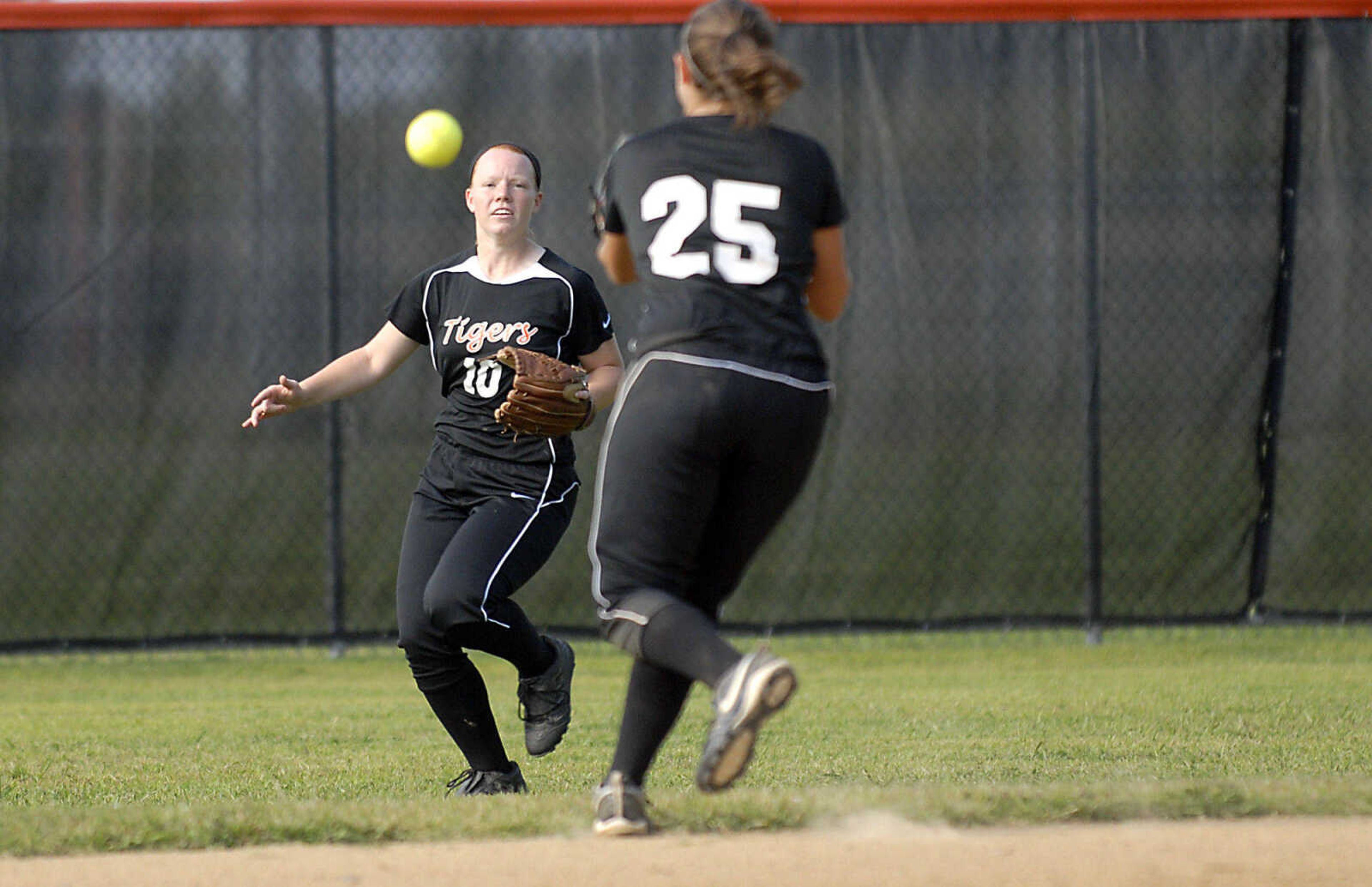 KIT DOYLE ~ kdoyle@semissourian.com
A short pop fly drops between Central right fielder Lexi Smith, left, and second baseman Tatiana Reagan Wednesday, September 2, 2009, in Cape Girardeau.