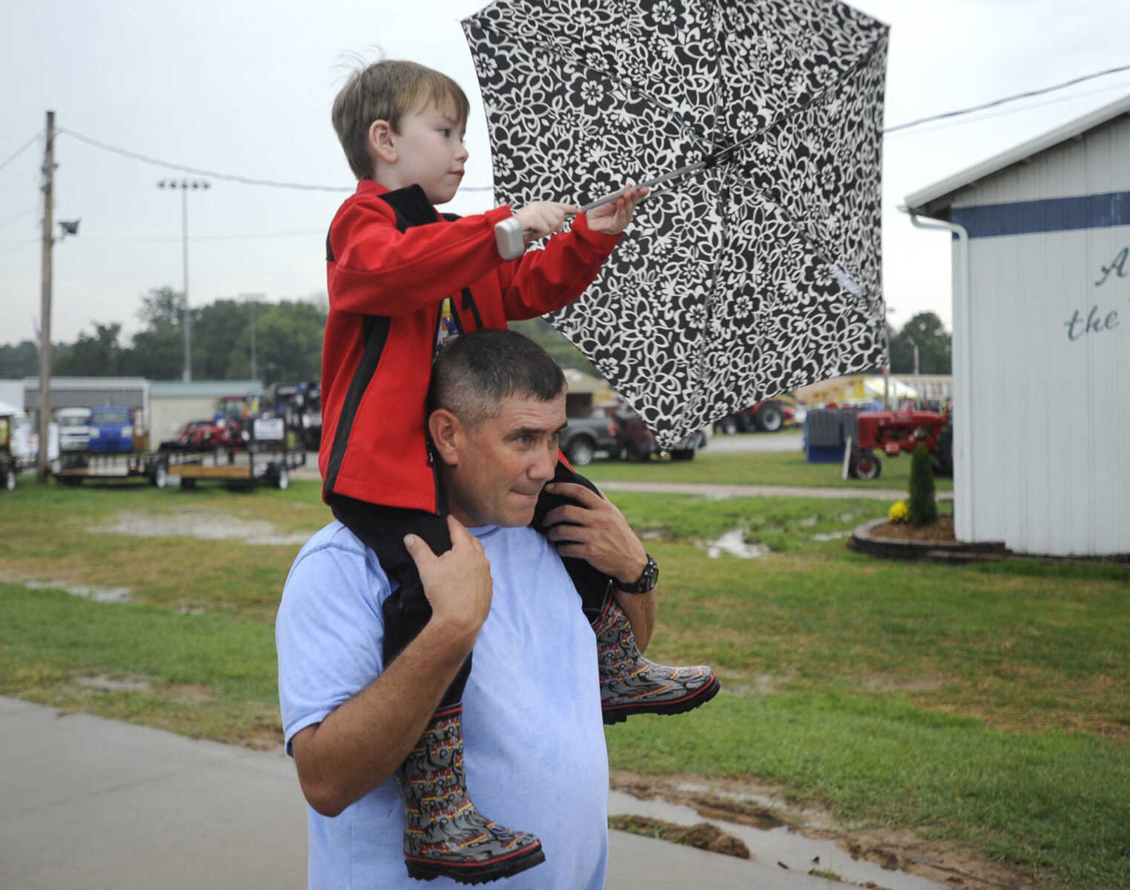 Tim Vick and his son, Hayden, of Cape Girardeau take in the SEMO District Fair Thursday, Sept. 15, 2016 in Cape Girardeau.