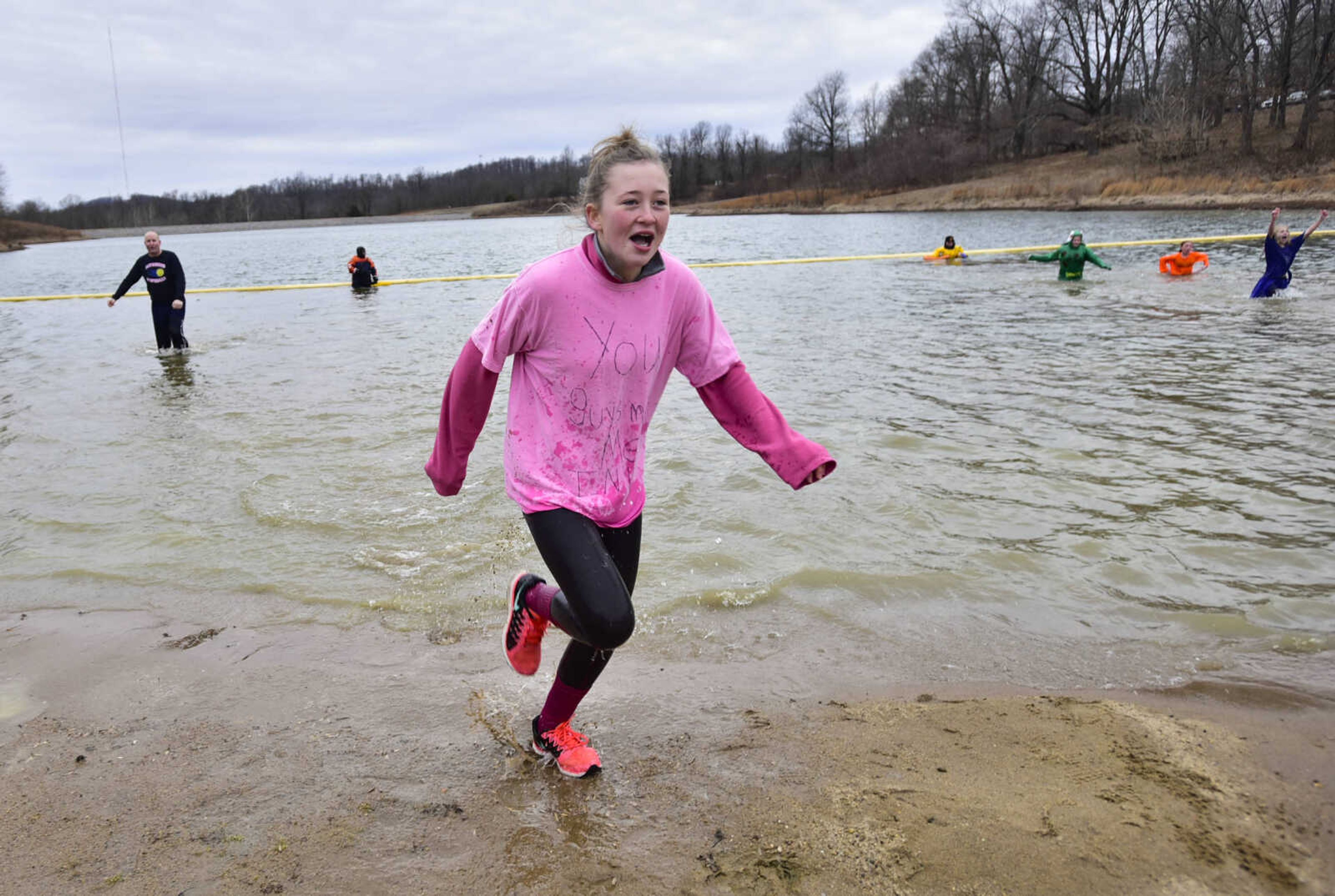 Plungers exit the water at the Polar Plunge benefit for Special Olympics Missouri on Saturday, Feb. 3, 2018, at Trail of Tears State Park.