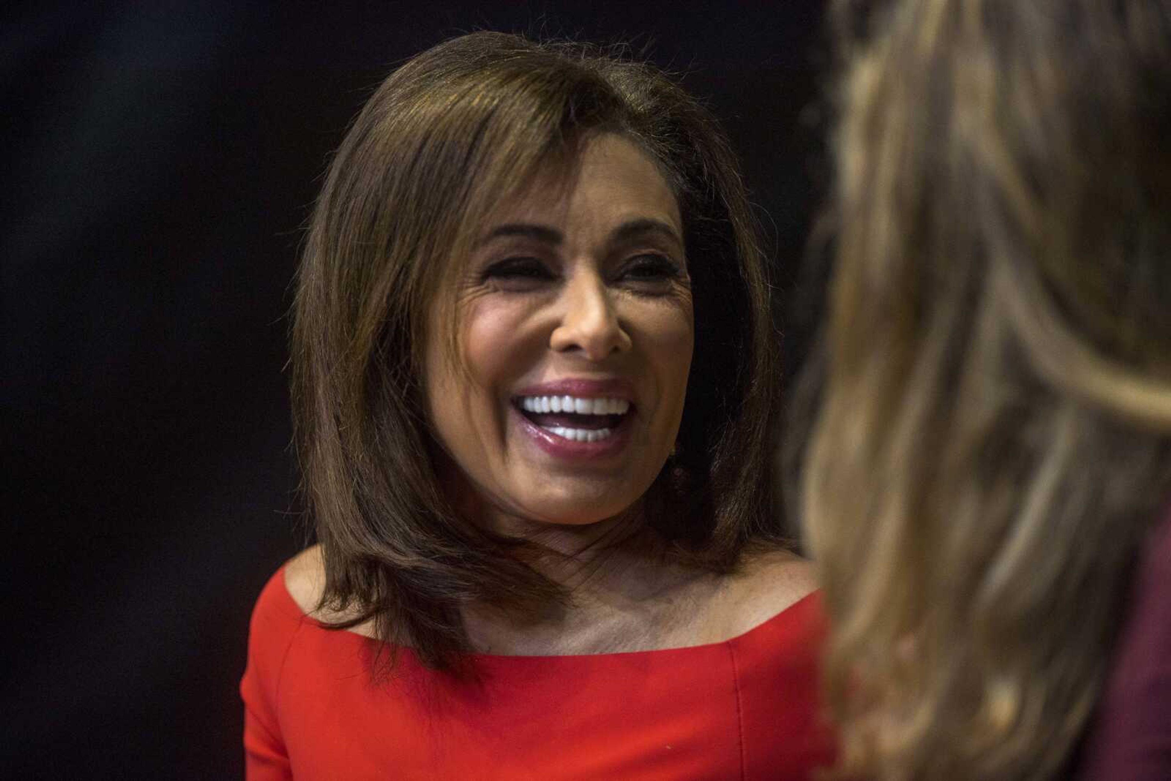 TV personality Jeanine Pirro laughs with another rally-goer at the Show Me Center before a rally for President Trump Monday.