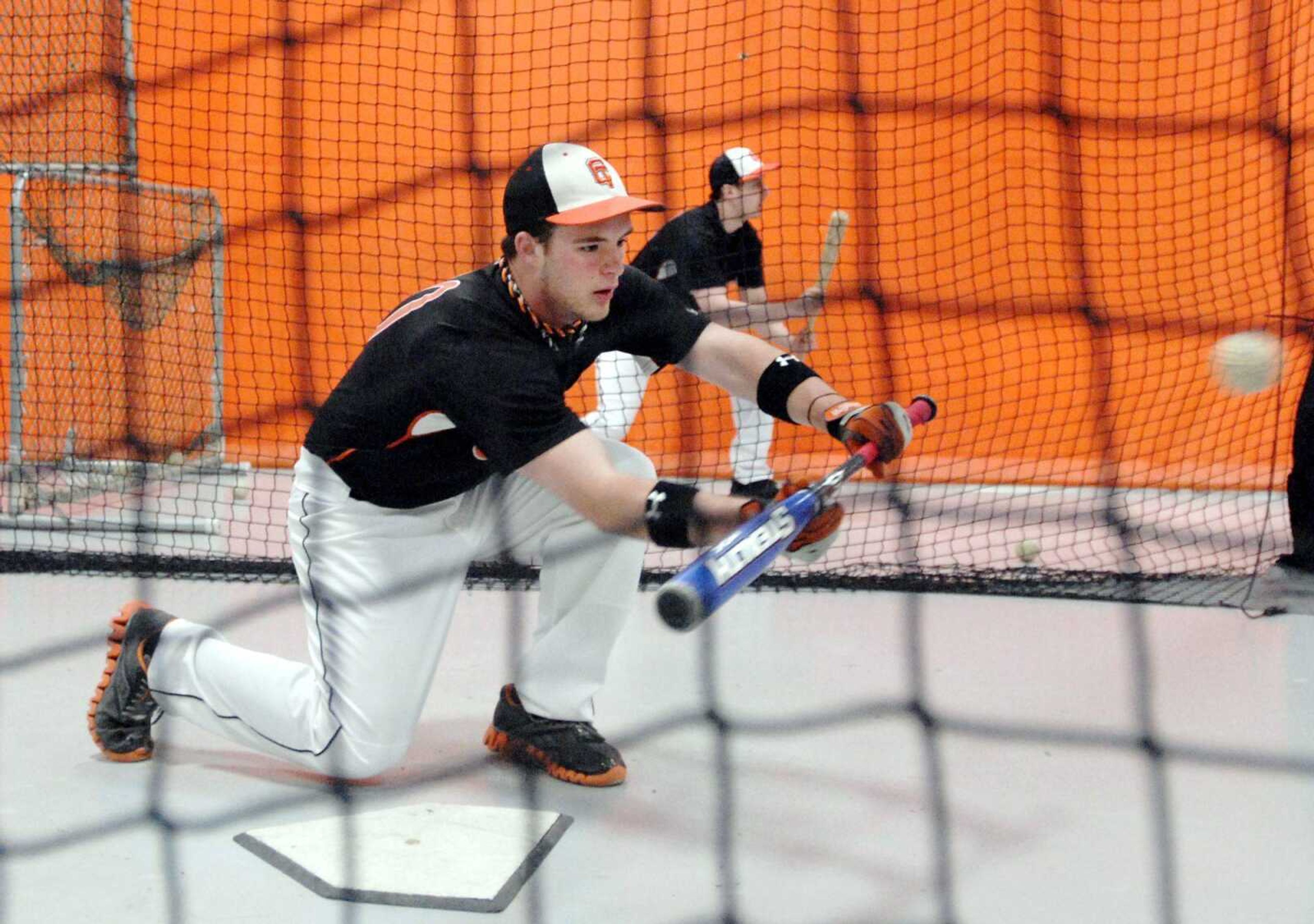 Central High School seniors Thomas Crocetti, front, and Patrick Ramsey participate Saturday in the baseball team's Bunt-a-thon at the high school. The players got pledges the week before and raised money for each ball out of 100 they bunted. (Laura Simon)