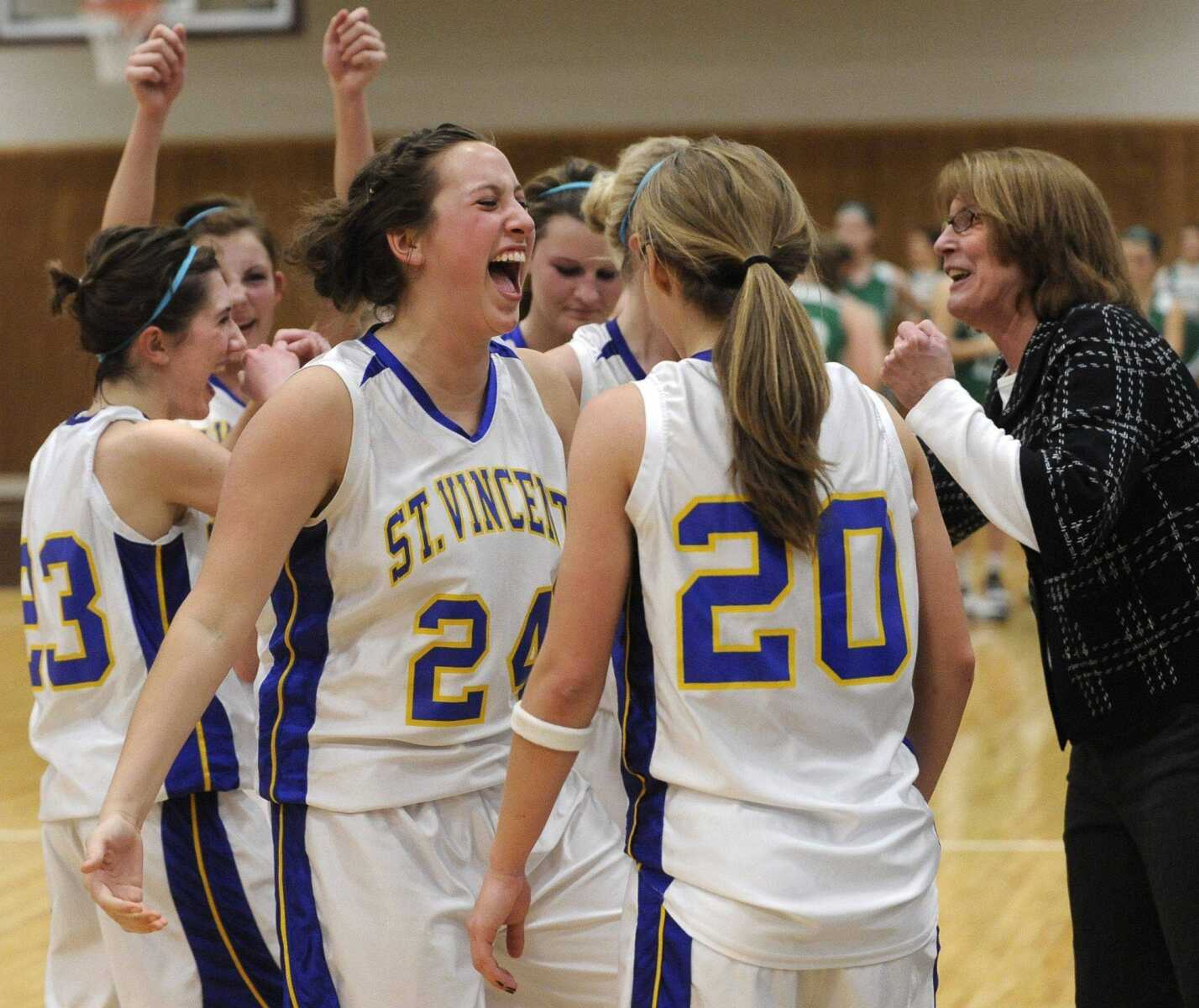 St. Vincent's Katie Mattingly, left, celebrates with her team and coach Terry Wengert after they defeated New Haven in the Class 2 District 4 title game Friday, March 4, 2011 in Perryville, Mo. (Fred Lynch)