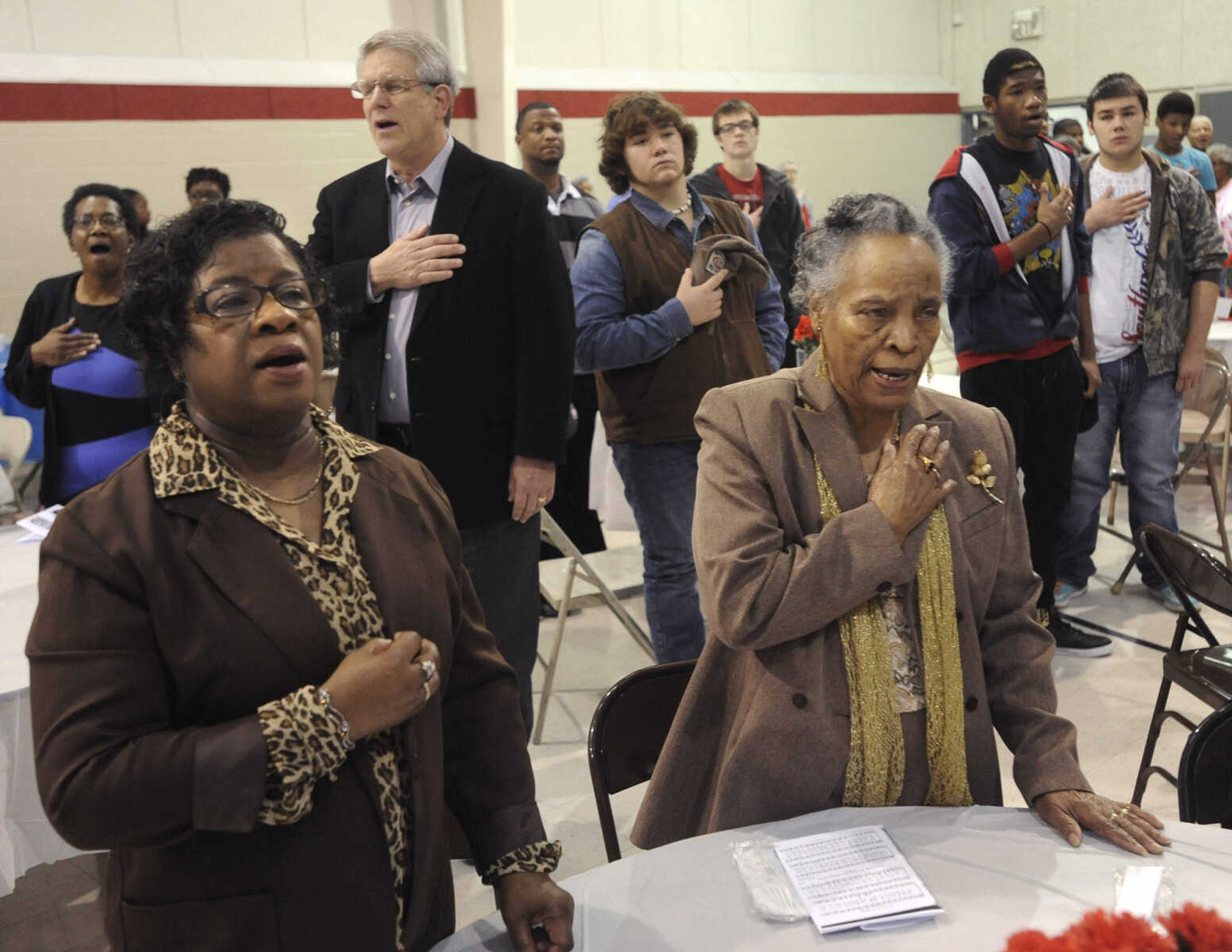 The audience stands for the national anthem at the Dr. Martin Luther King Jr. Memorial Breakfast Monday, Jan. 19, 2015 at the Salvation Army in Cape Girardeau.