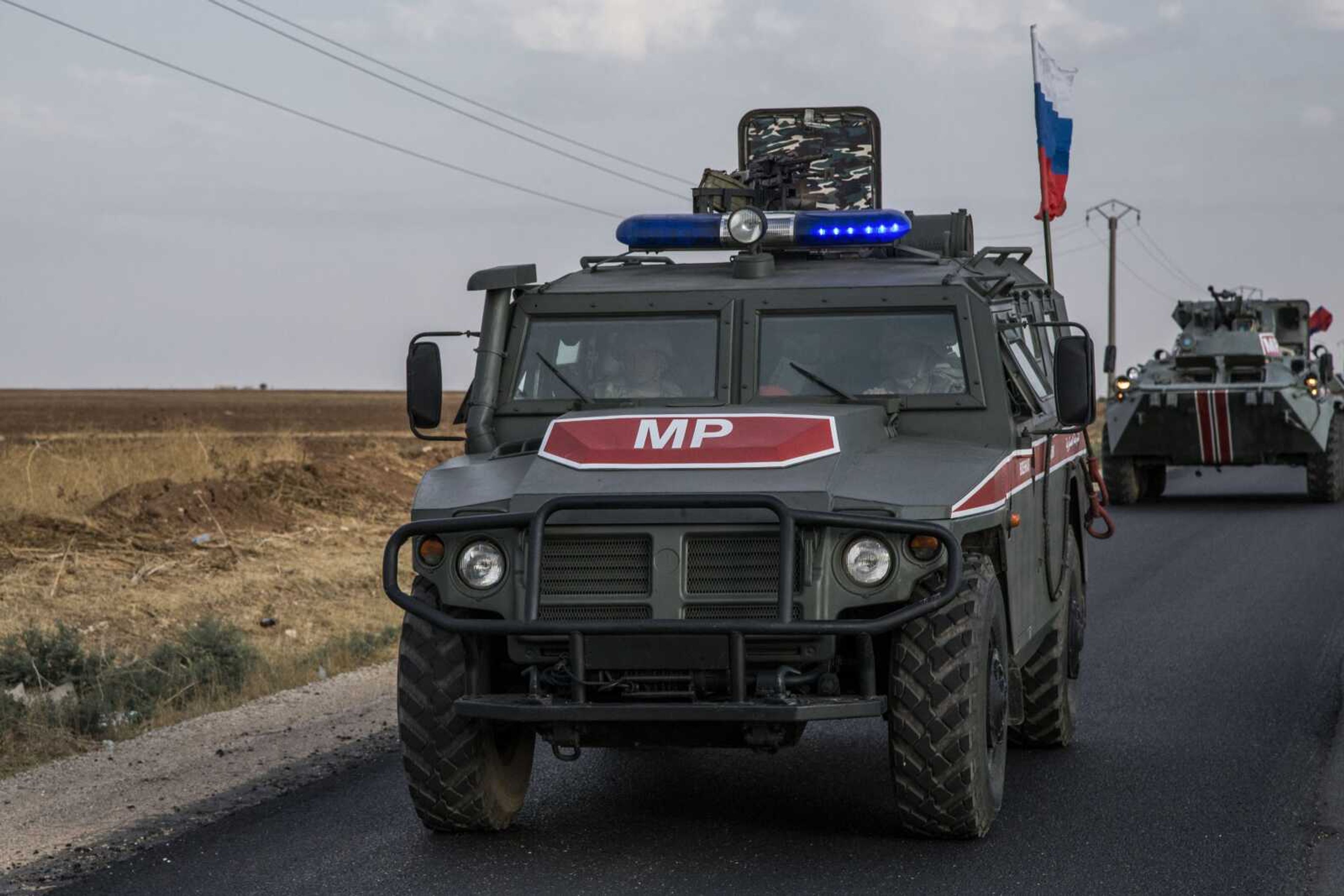 Russian forces patrol near the city of Qamishli, north Syria, Thursday, Oct. 24, 2019. Syrian forces, Russian military advisers and military police are being deployed in a zone 30 kilometers (19 miles) deep along much of the northeastern border, under an agreement reached Tuesday by Russia and Turkey. (AP Photo/Baderkhan Ahmad)