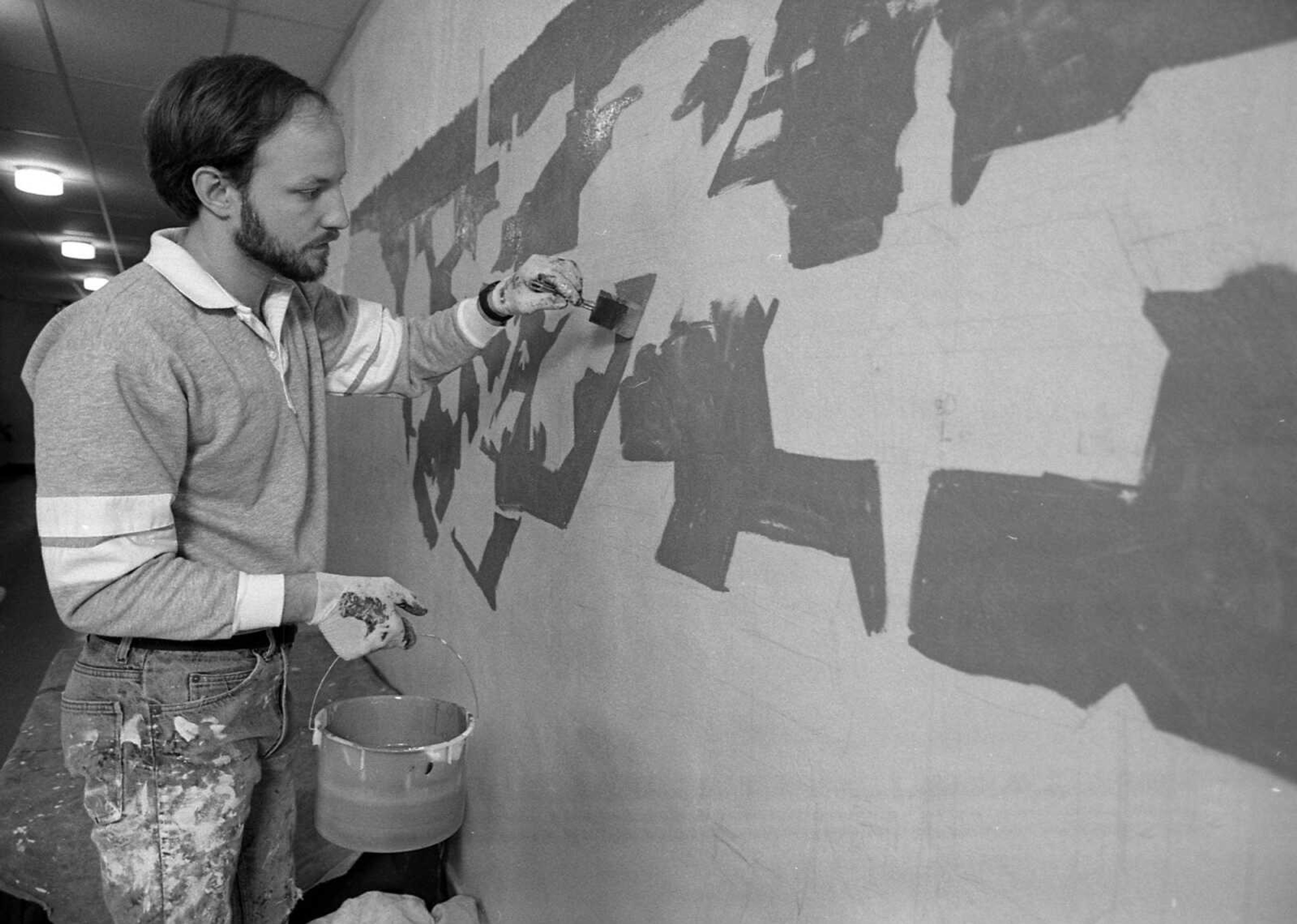 MARCH 29, 1988
"Transportation on the River" is the theme of the 85-foot-long, 10-foot high mural that Jackson artist Craig Thomas is painting on the walls of Washington School in Cape Girardeau. The mural, which is a view of Cape Girardeau including several boats on the Mississippi and the river bridge, is funded through the elementary school's PTA and Centerre Bank, Washington School's Adopt-a-School partner.