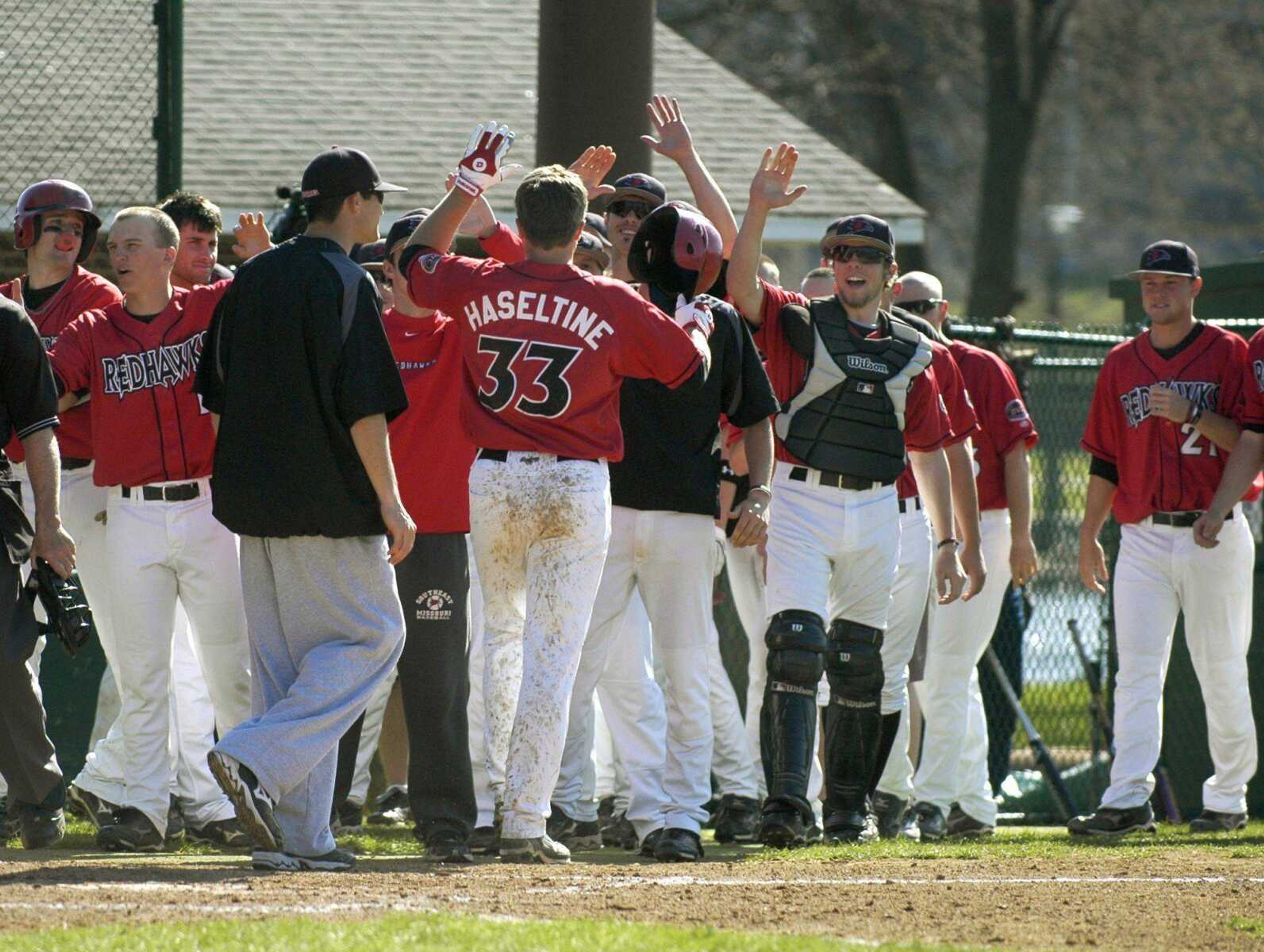 Southeast Missouri State teammates congratulate Louie Haseltine after he hit a grand slam against Saint Louis University during Tuesday's game at Capaha Field. (KRISTIN EBERTS)