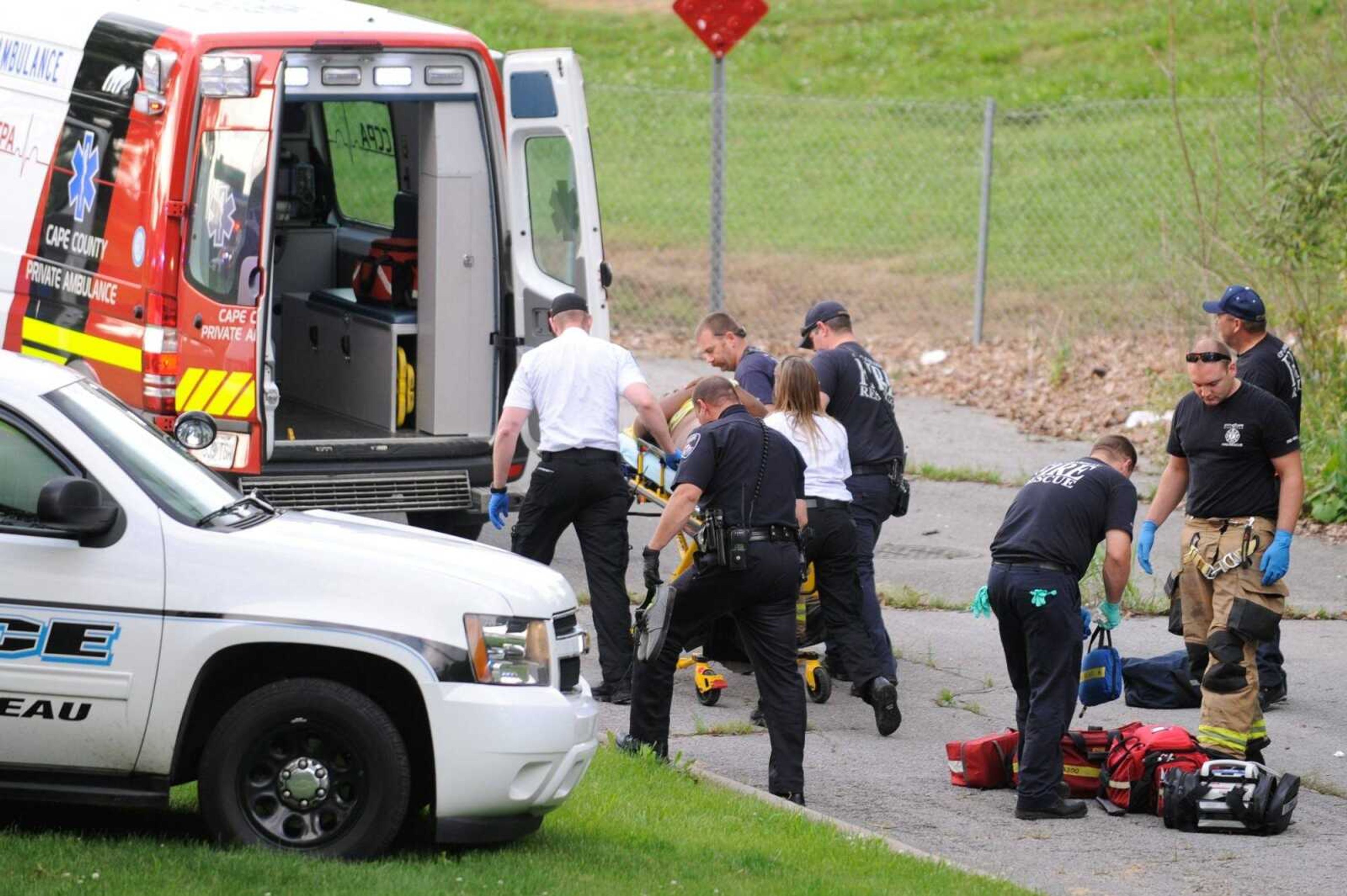 Members of the Cape Girardeau Police Department, Cape County Private Ambulance and the Cape Girardeau Fire Department load the victim of a shooting into an ambulance at Ranney Park in Cape Girardeau shortly after 6 p.m. Sunday. (Glenn Landberg)