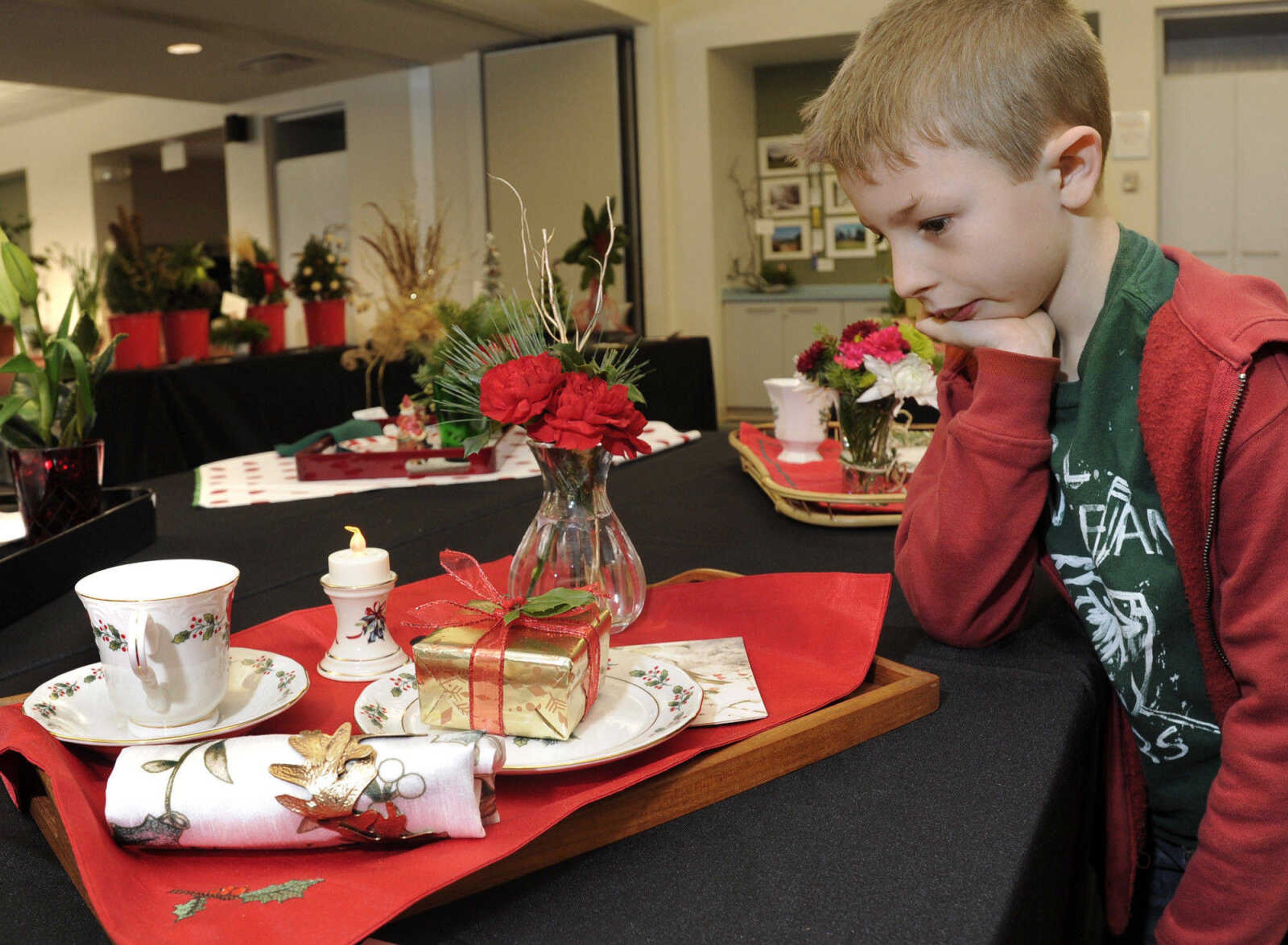 Lucas Cheatham of Jackson views a functional tray for one that was designed by Jennifer Lipps of the Ramblewood Garden Club.