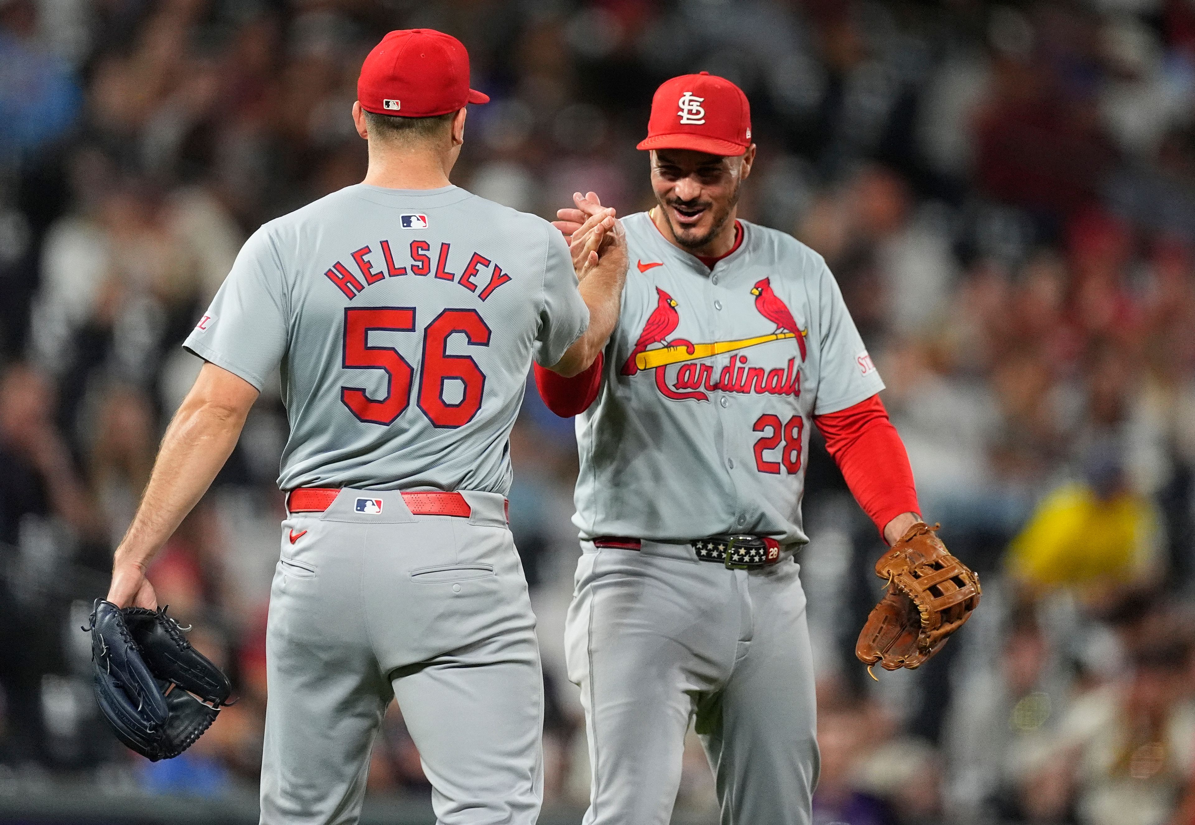 St. Louis Cardinals relief pitcher Ryan Helsley, front, is congratulated by third baseman Nolan Arenado after getting Colorado Rockies' Sam Hilliard to hit into a game-ending double play on one pitch in a baseball game, Wednesday, Sept. 25, 2024, in Denver. (AP Photo/David Zalubowski)