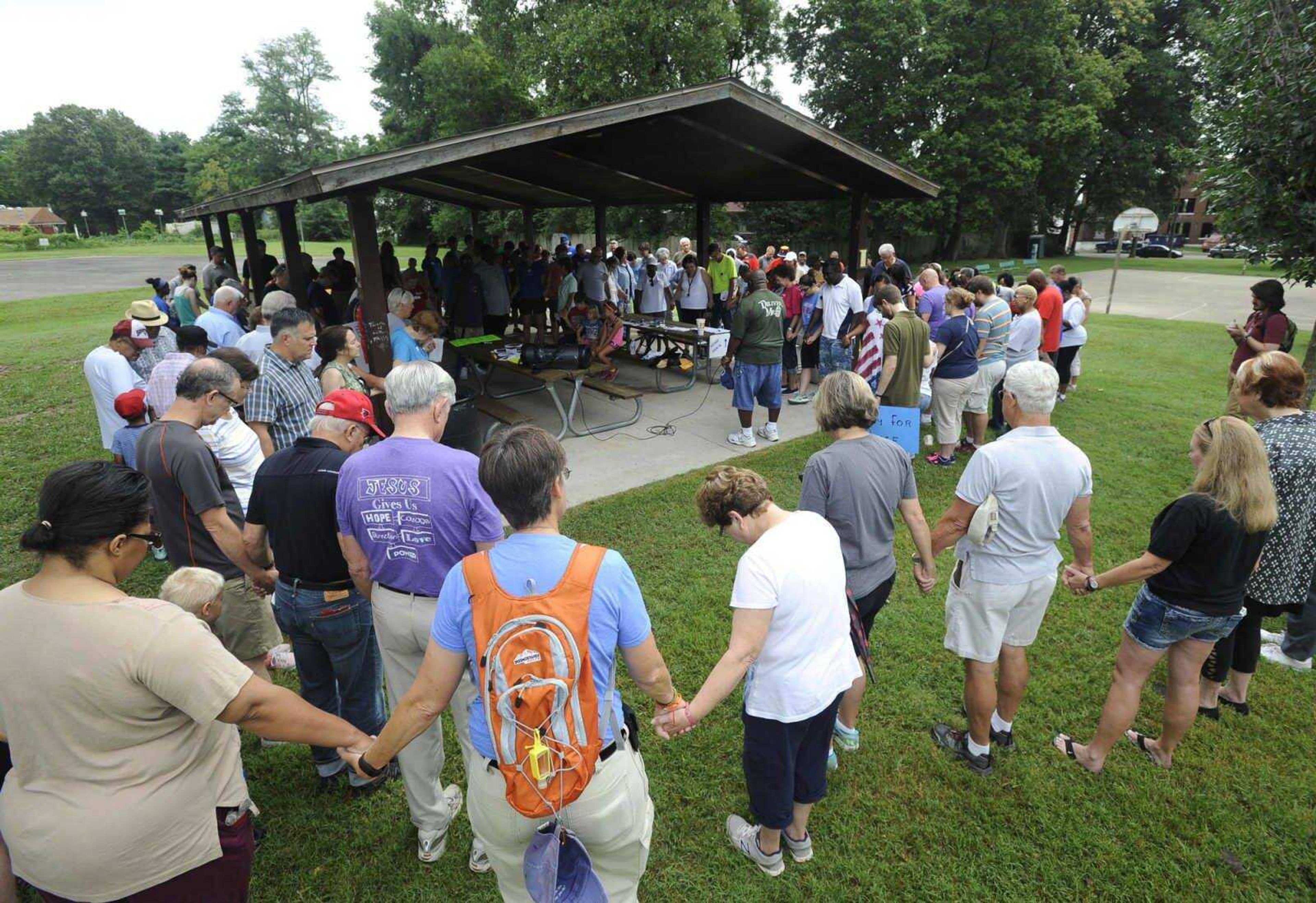 The Rev. Byron Bonner leads a prayer July 30, 2016, at Indian Park before the Stop Needless Acts of Violence Please (SNAP) prayer march in Cape Girardeau.