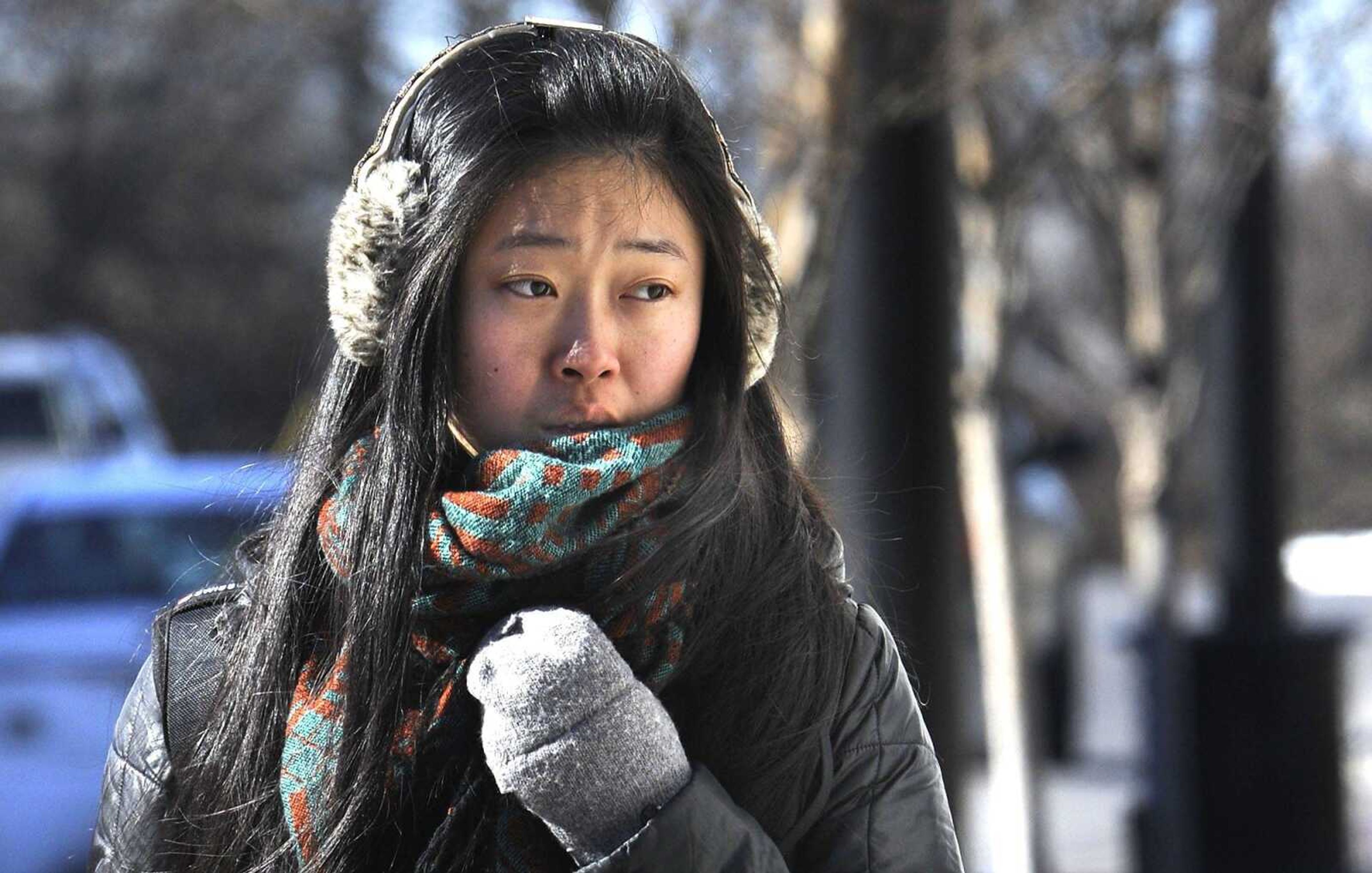 Jingshi Yao walks down Broadway dressed for the 15-degree temperature Monday, Jan. 18, 2016 in Cape Girardeau. With classes out at Southeast Missouri State University for the Martin Luther King Jr. holiday, the student from China decided to get out for some light shopping. (Fred Lynch)