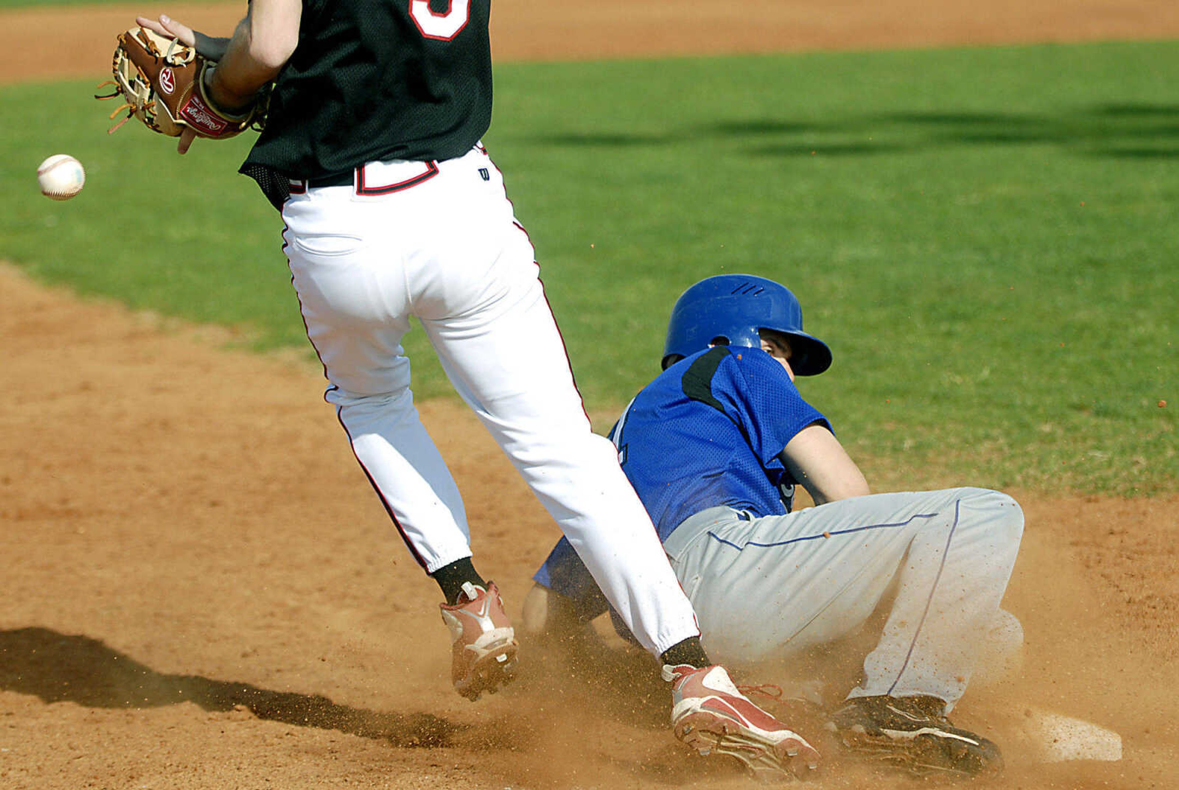 Notre Dame senior Austin Greer safely advances to third base Tuesday, April 28, 2009, against Sikeston in Cape Girardeau.  Greer then scored as the ball got away from Sikeston's Jordan Williams.