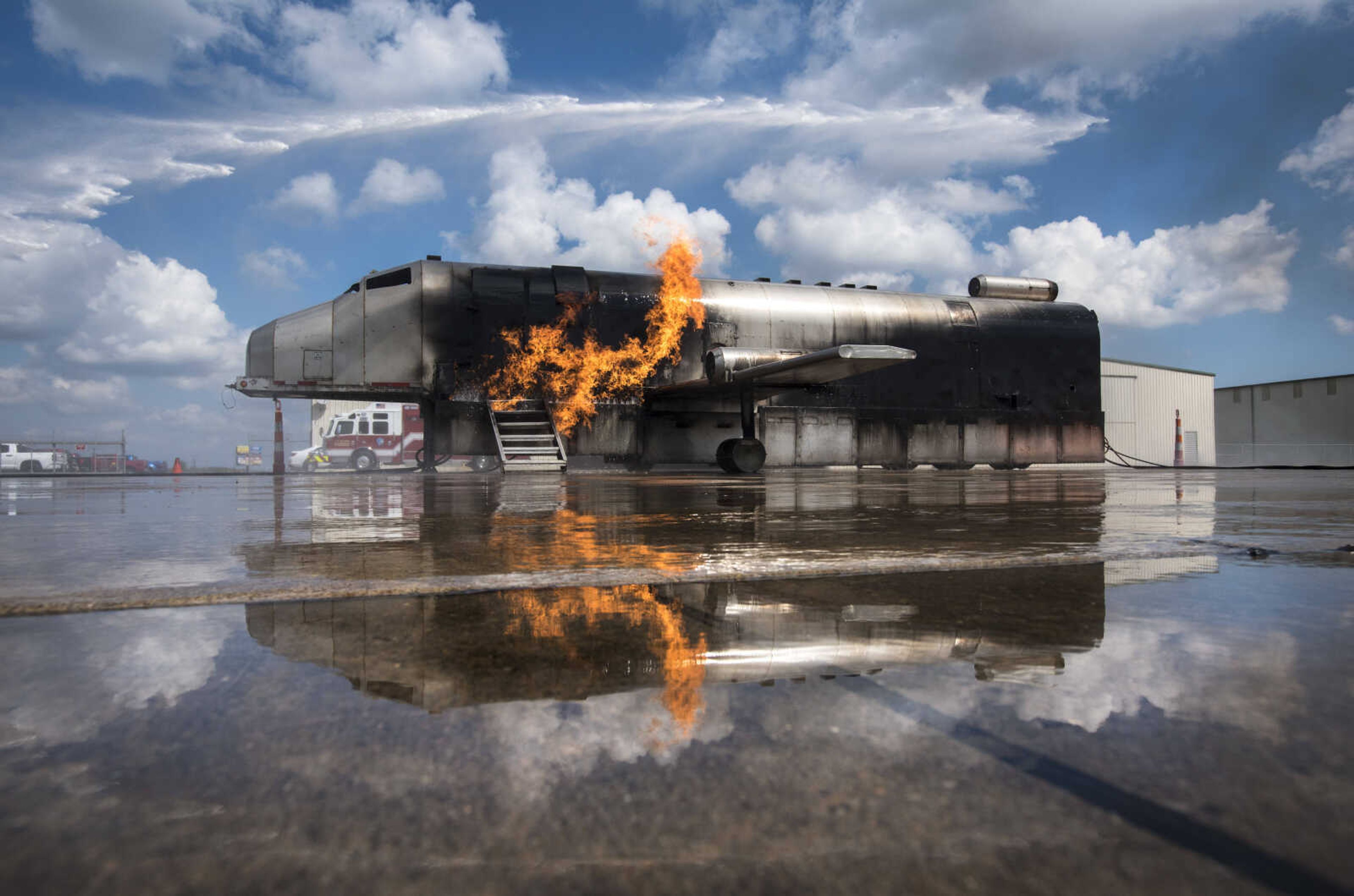 A firefighter guiding a firetruck hose puts out a ground fire and aircraft fire while area firefighters from Cape Girardeau, Gordonville and Scott City run airplane fire drills at the Cape Girardeau Regional Airport Friday morning, Sept. 15, 2017 in Cape Girardeau.