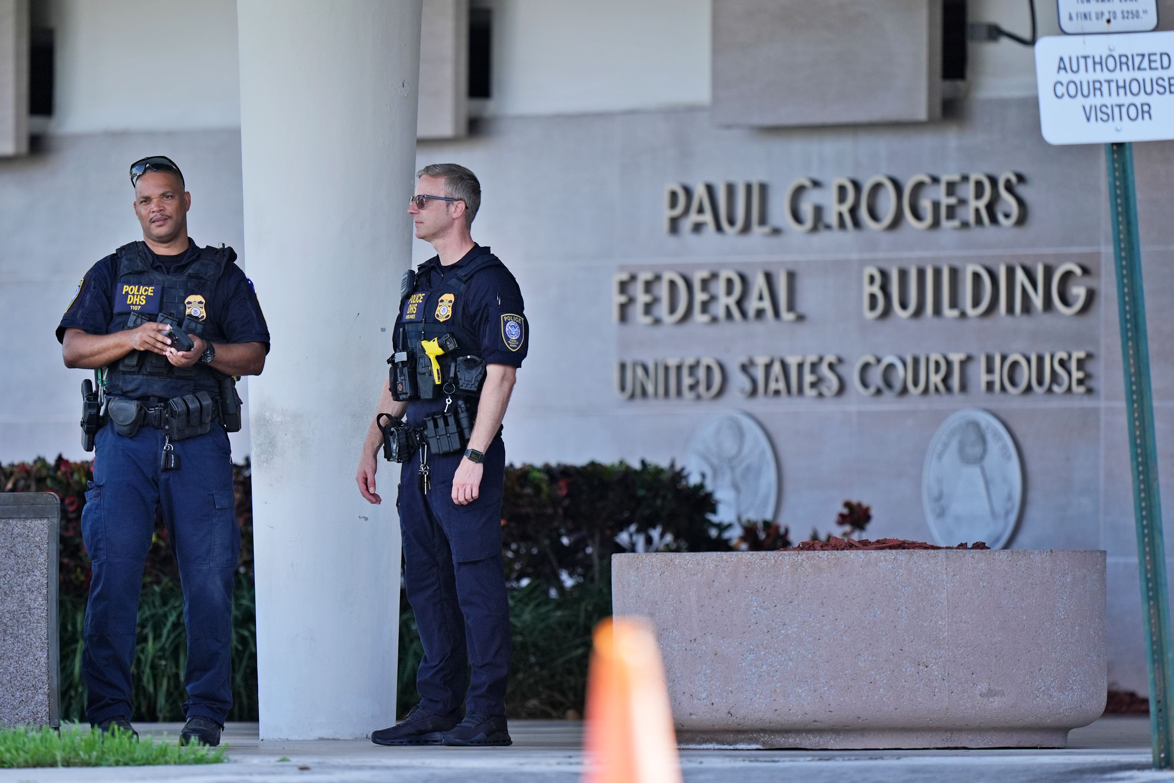 Department of Homeland Security officers patrol outside the Paul G. Rogers Federal Building and U.S. Courthouse, where a man suspected in an apparent assassination attempt targeting former President Donald Trump, was charged with federal gun crimes, Monday, Sept. 16, 2024, in West Palm Beach, Fla. (AP Photo/Wilfredo Lee)