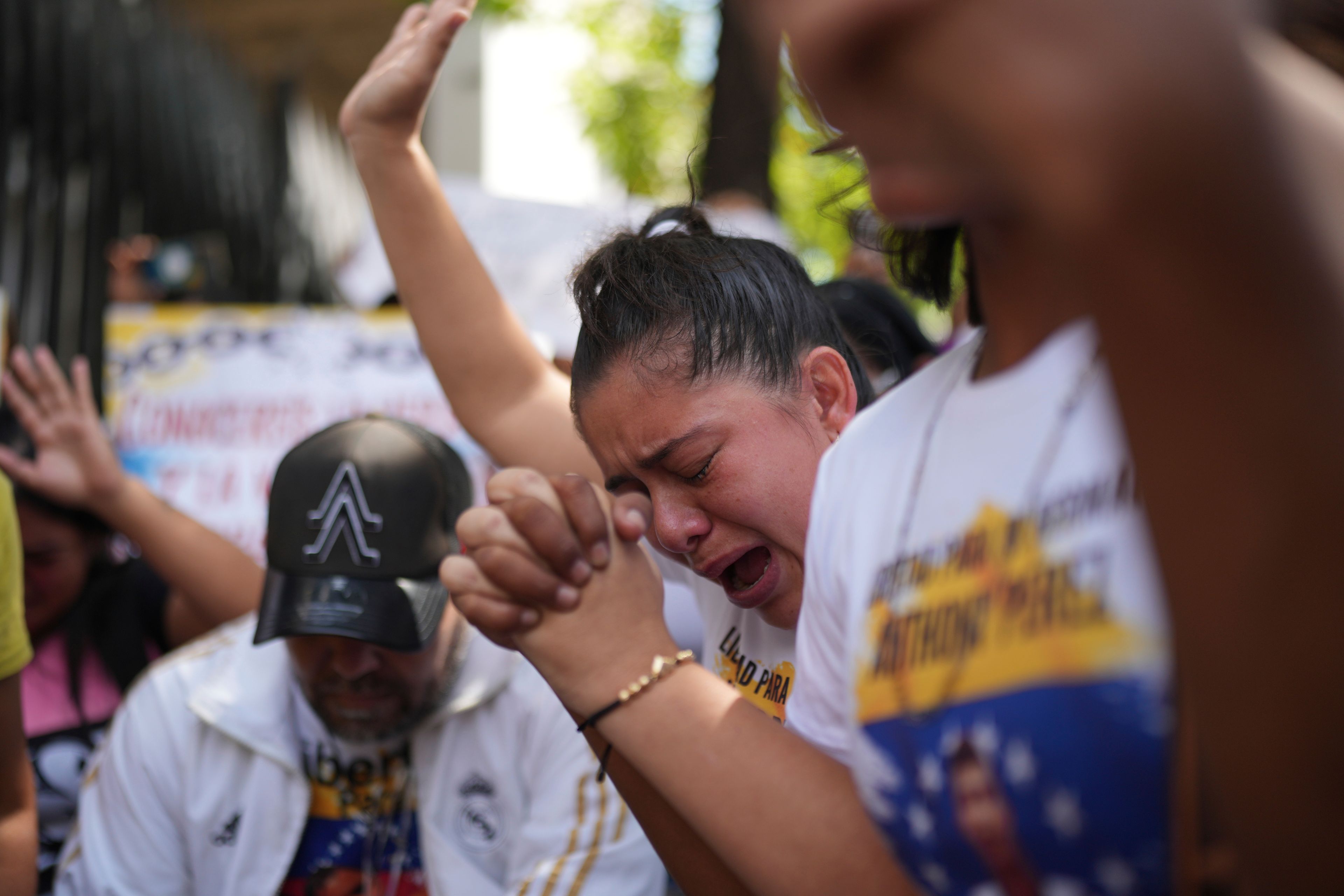 The sister of Keimer Puentes cries during a protest for the freedom of her brother and other detainees outside the Palace of Justice courts in Caracas, Venezuela, Thursday, Nov 7, 2024. According to her, who did not want to be identified, Puentes was detained by police on July 29 while leaving his home in the city of Tachira as part of a government crackdown after demonstrations against presidential election results. (AP Photo/Ariana Cubillos)