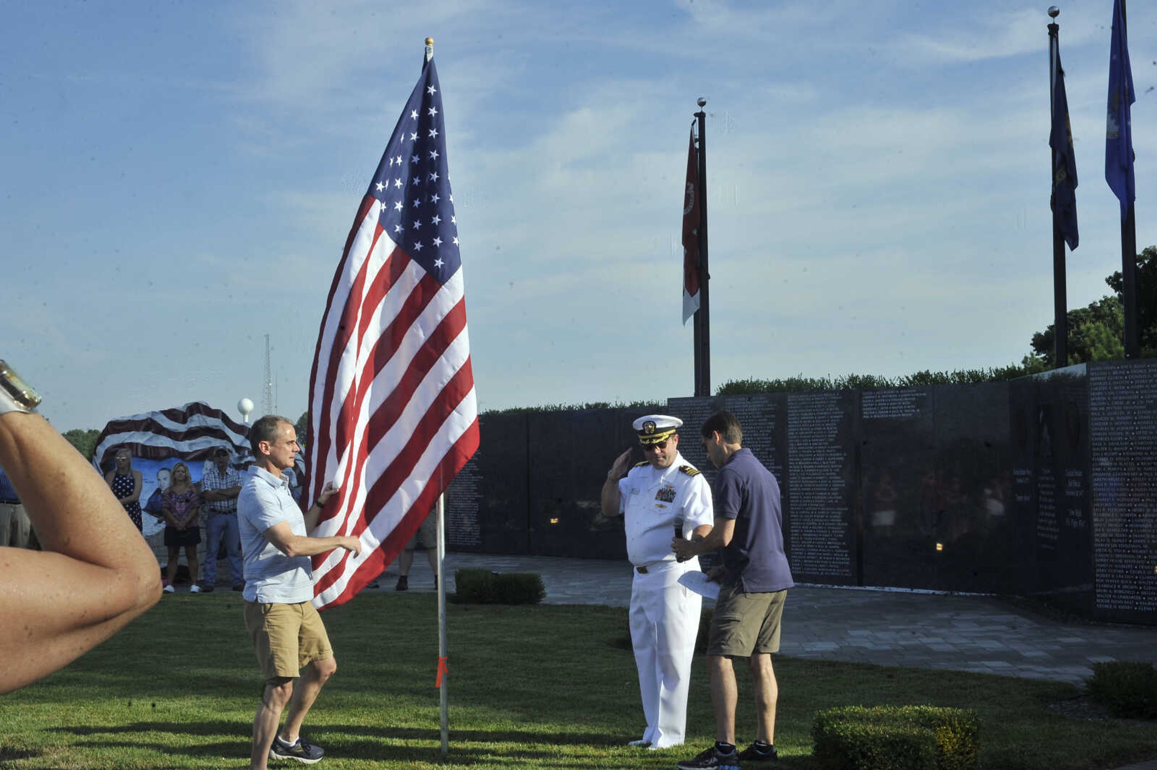 Clint Tracy introduces the first speaker during the Avenue of Flags flag dedication ceremony.&nbsp;