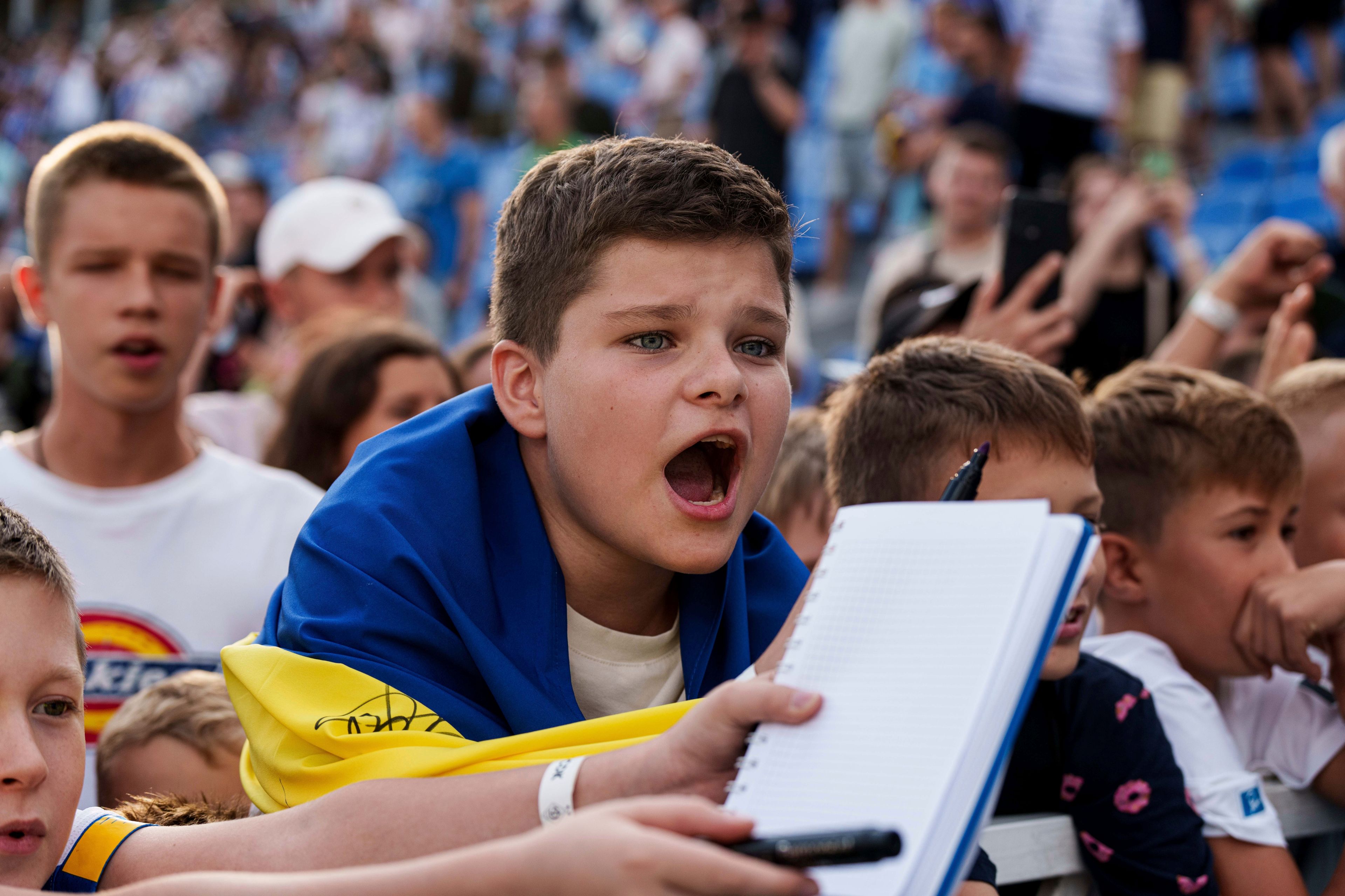 Young fans urge players to sign autographs after a soccer match of Dynamo Kyiv and Zorya Luhansk in Kyiv, Ukraine, Saturday Sept. 14, 2024. (AP Photo/Evgeniy Maloletka)