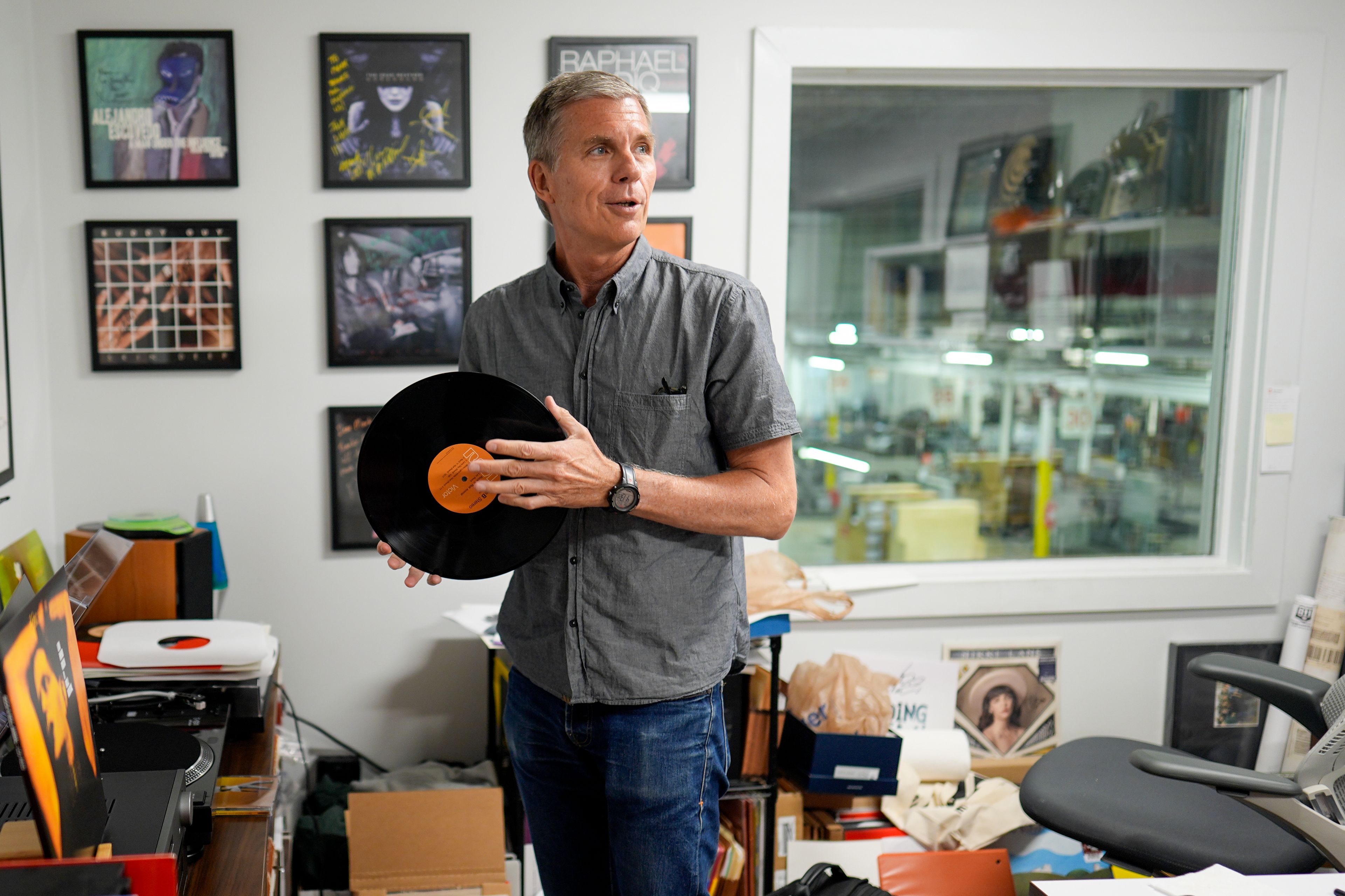 Mark Michaels, CEO & Chairman of United Record Pressing, hold a vinyl recored in his office July 11, 2024, in Nashville, Tenn. (AP Photo/George Walker IV)