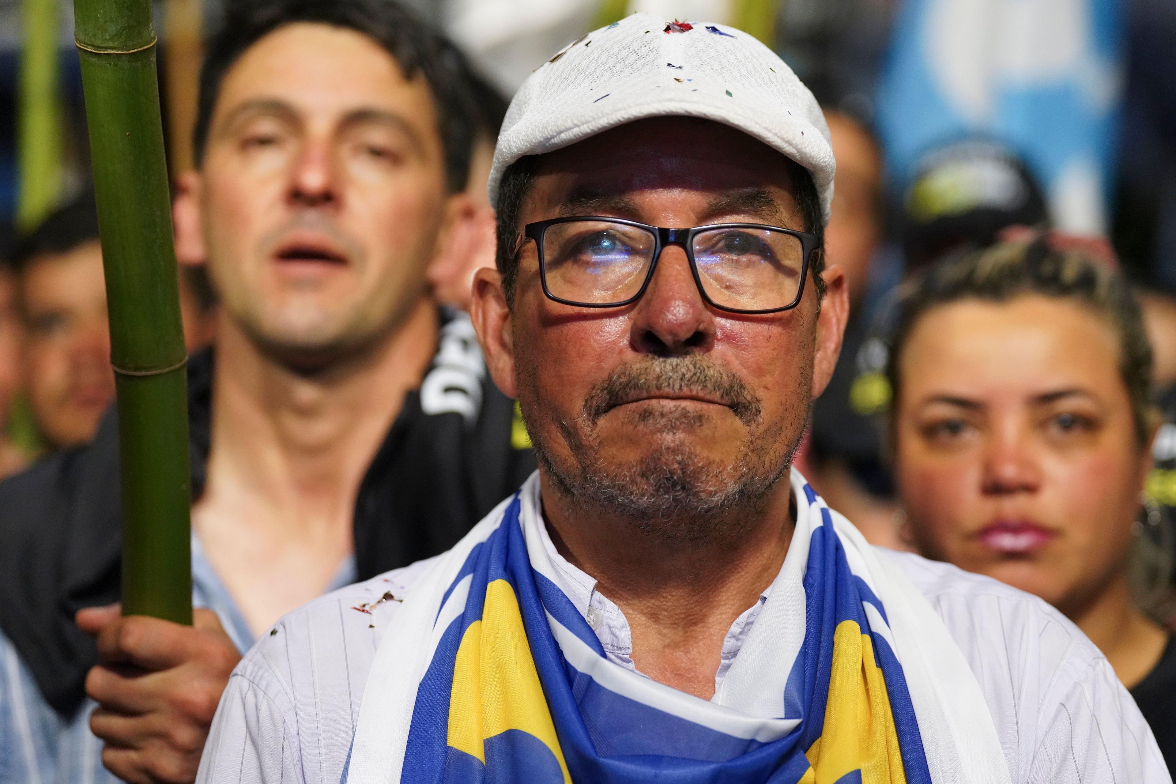 A supporter of Alvaro Delgado, presidential candidate for the ruling National Party, attends a rally six days ahead of presidential elections, in Maldonado, Uruguay, Monday, Oct. 21, 2024. (AP Photo/Matilde Campodonico)