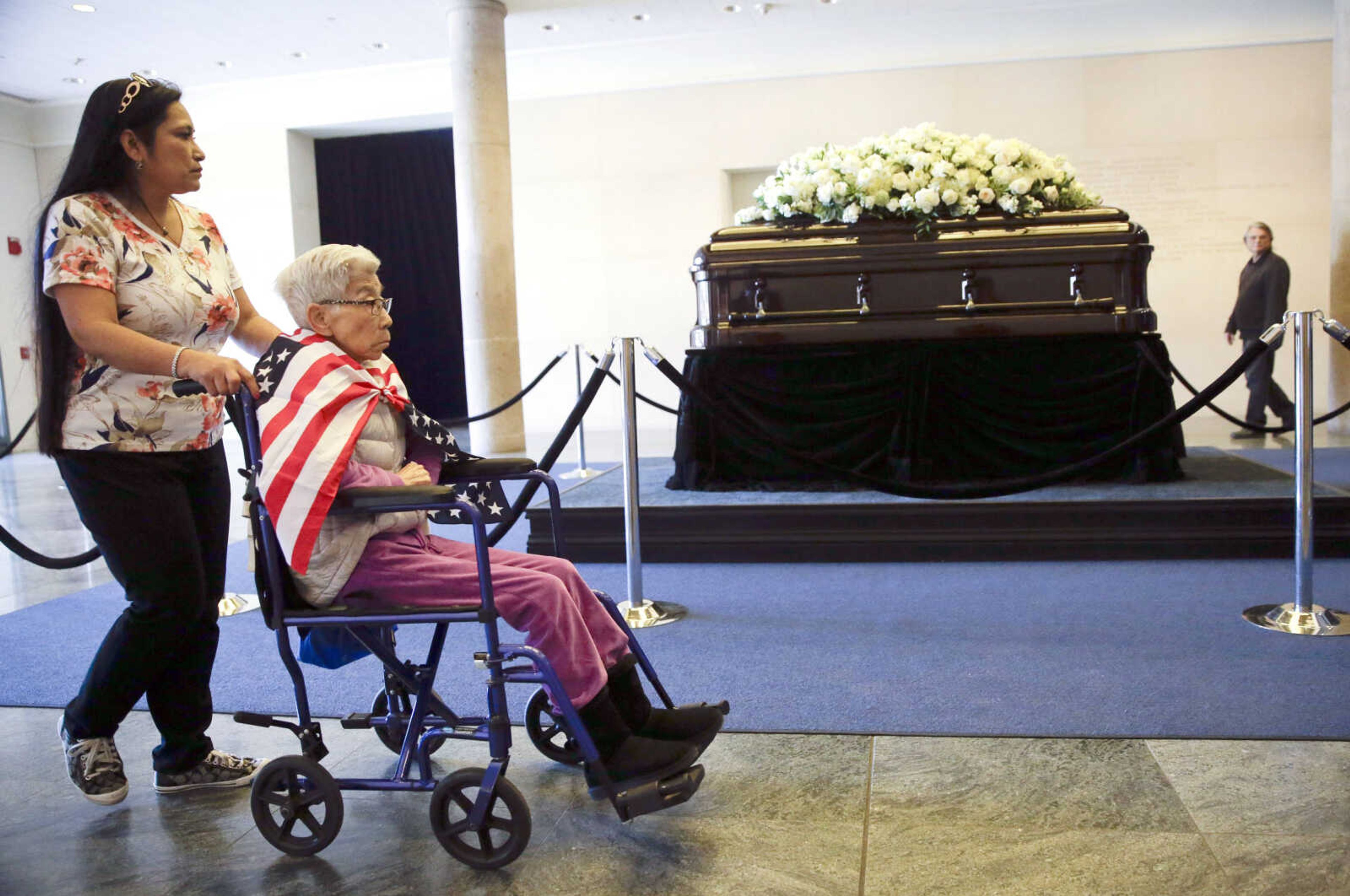 Stella Delgado, left, and her mother, Yoko Santos, pause as they pay their respects beside the casket of Nancy Reagan at the Ronald Reagan Presidential Library on Wednesday in Simi Valley, California.