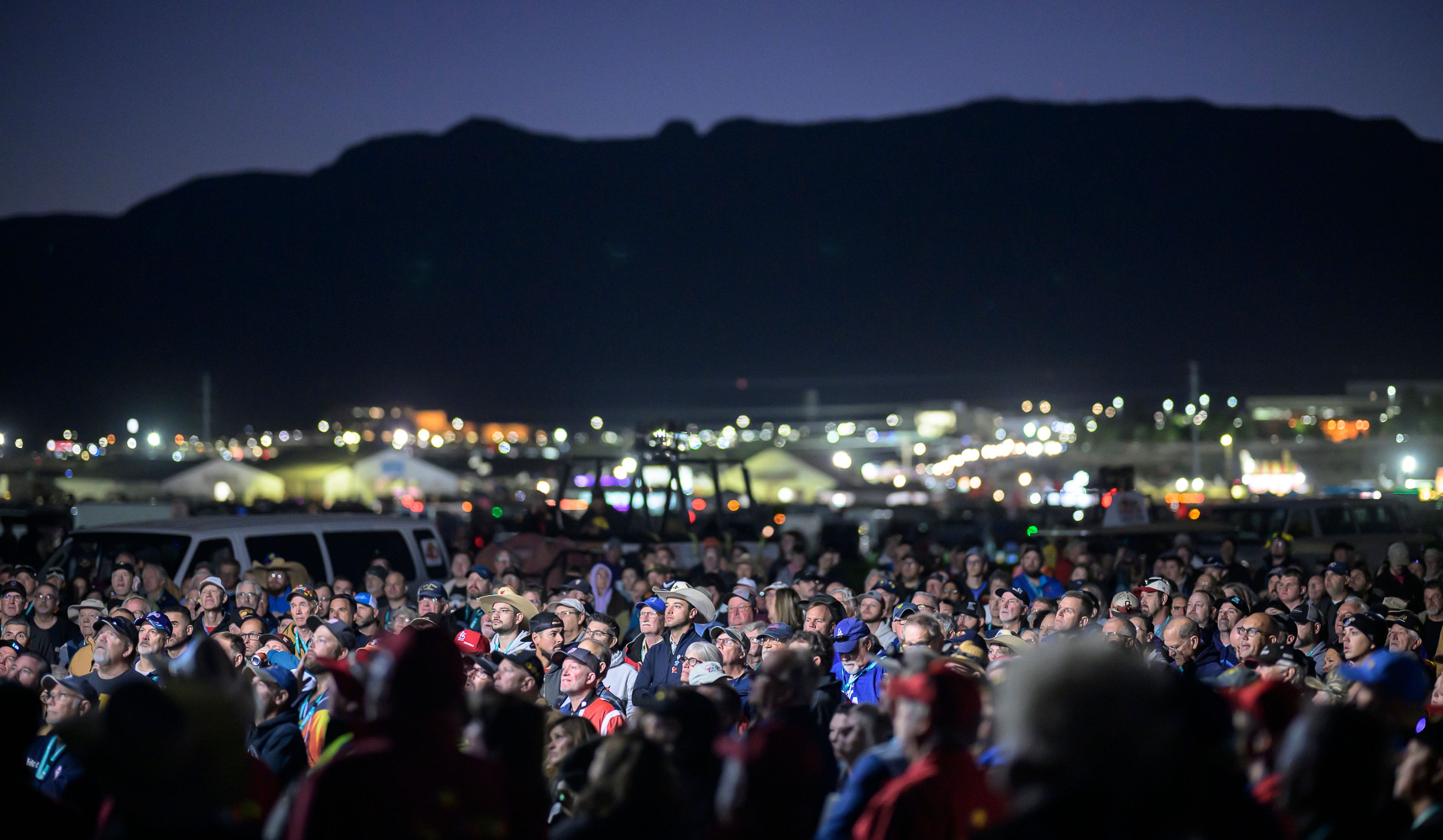 Pilots gather for a briefing just before sunrise prior to the start of the 52nd Albuquerque International Balloon Fiesta in Albuquerque, N.M., on Saturday, Oct. 5, 2024. (AP Photo/Roberto E. Rosales)