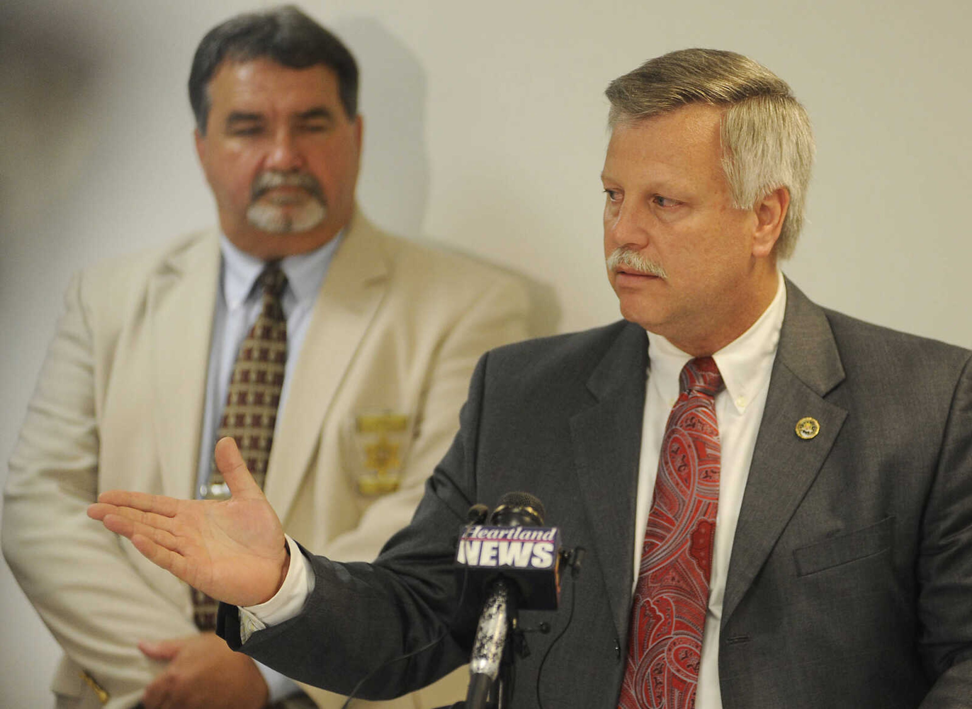 Cape Girardeau County Sheriff John Jordan watches, left, as JDean Bryant, special agent in charge of the St. Louis field office of the FBI, speaks during a news conference Thursday, June 6, 2013, at the Cape Girardeau County Sheriff's Office after a hearing at the Cape Girardeau County Courthouse where Clay Waller pleaded guilty to killing his wife, Jacque Waller, on June 1, 2011.