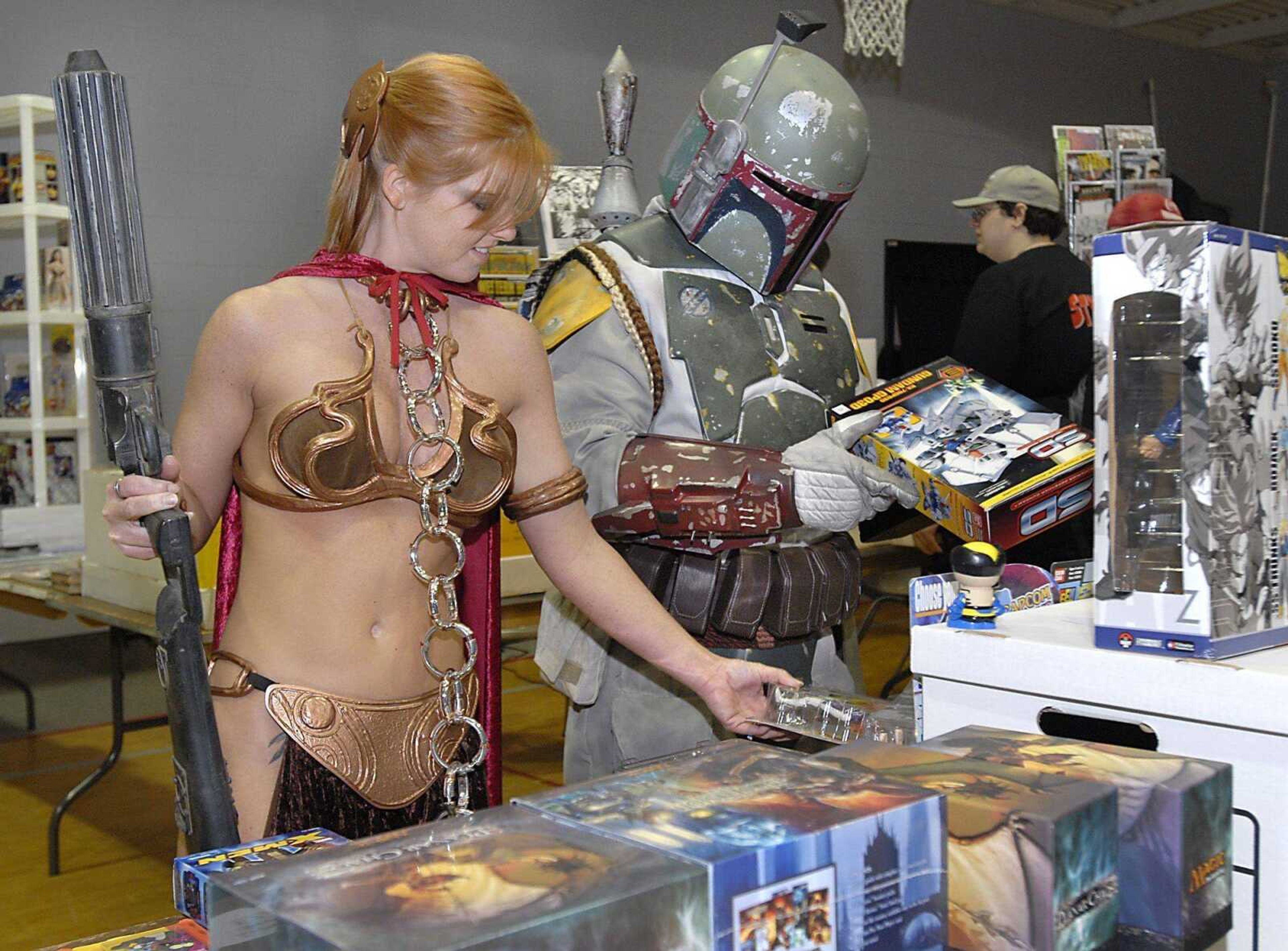 Summer Ramey as Slave Leia and Ivan Matos as Boba Fett browse items offered at the 2008 Cape Comic Con in Cape Girardeau. (Southeast Missourian file photo)