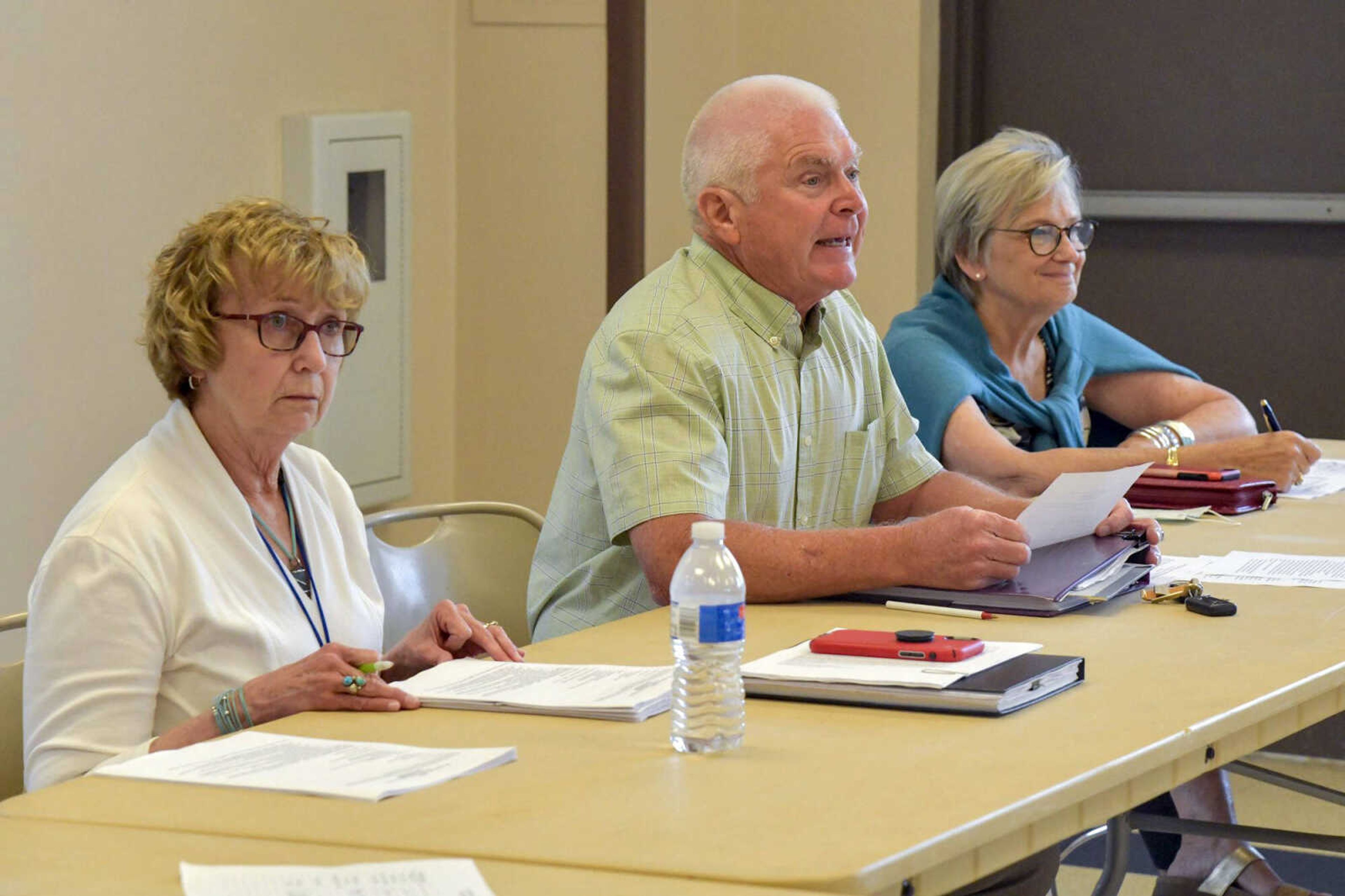 Cape Girardeau County Public Health Center board chairman John Freeze, center, opens the board’s meeting Tuesday at Shawnee Park Center in Cape Girardeau. Freeze began the meeting by announcing door-to-door visits promovting COVID-19 vaccinations will not happen in Cape Girardeau County, the board has no plans to issue a mask order and they will not take public comment until their meeting in August.