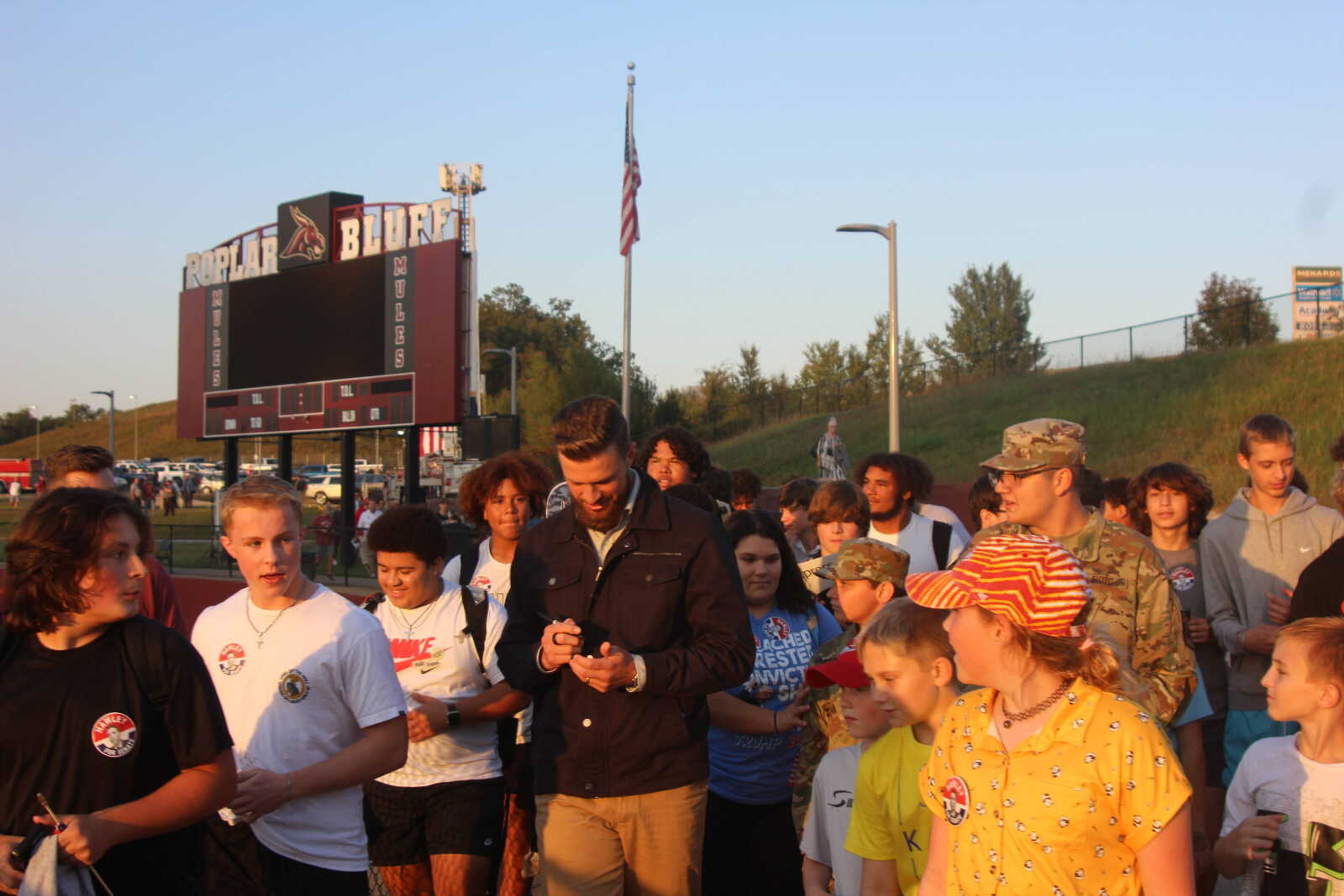 Kansas City Chiefs kicker Harrison Butker, center, signs autographs Thursday, Oct. 10, at Mules Stadium in Poplar Bluff.