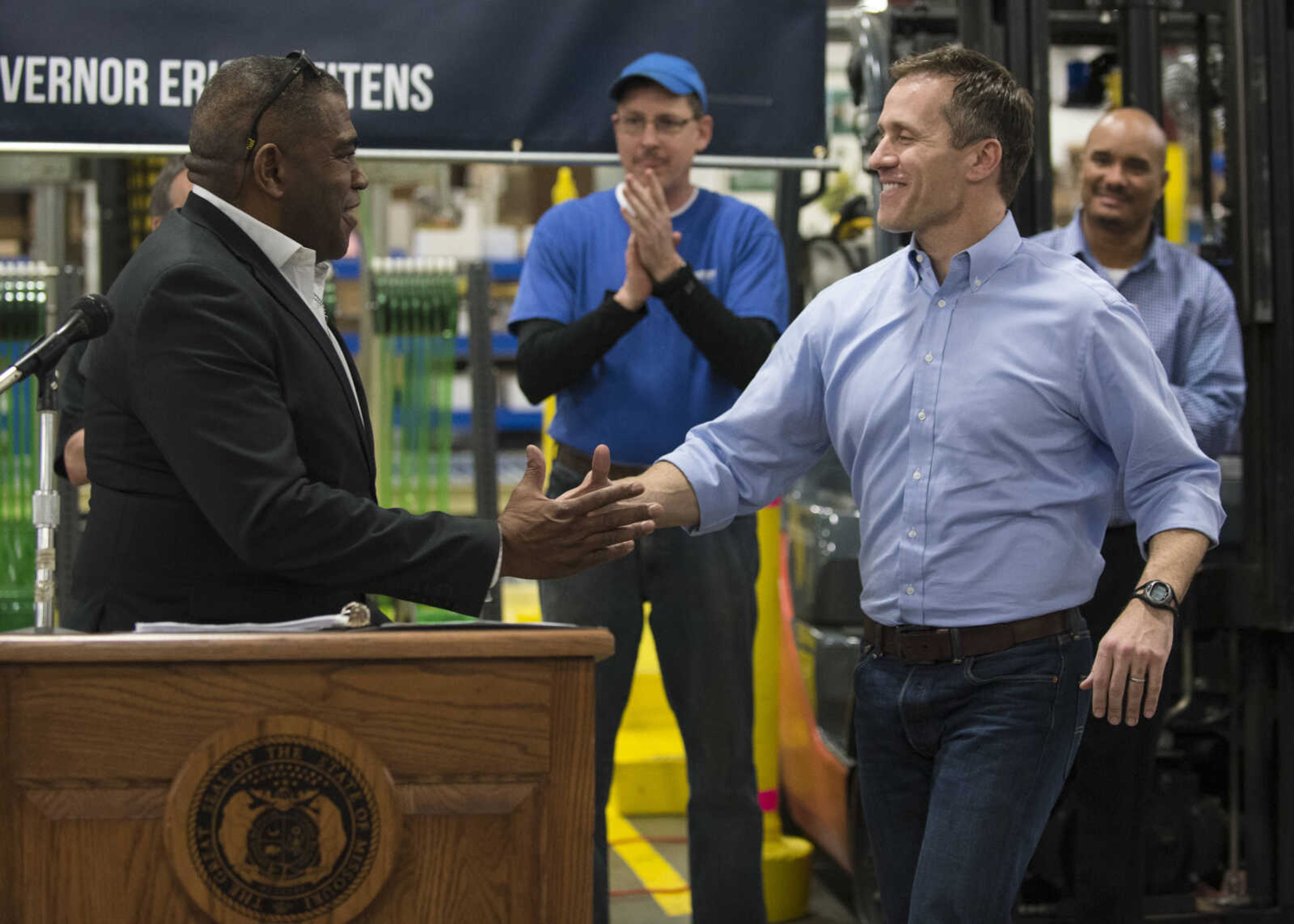 Dennis Vinson, left, president and CEO of Signature Packaging and Paper, welcomes Governor Eric Greitens to the podium on Jan. 29, 2018, during the governor's visit to discuss tax cuts.