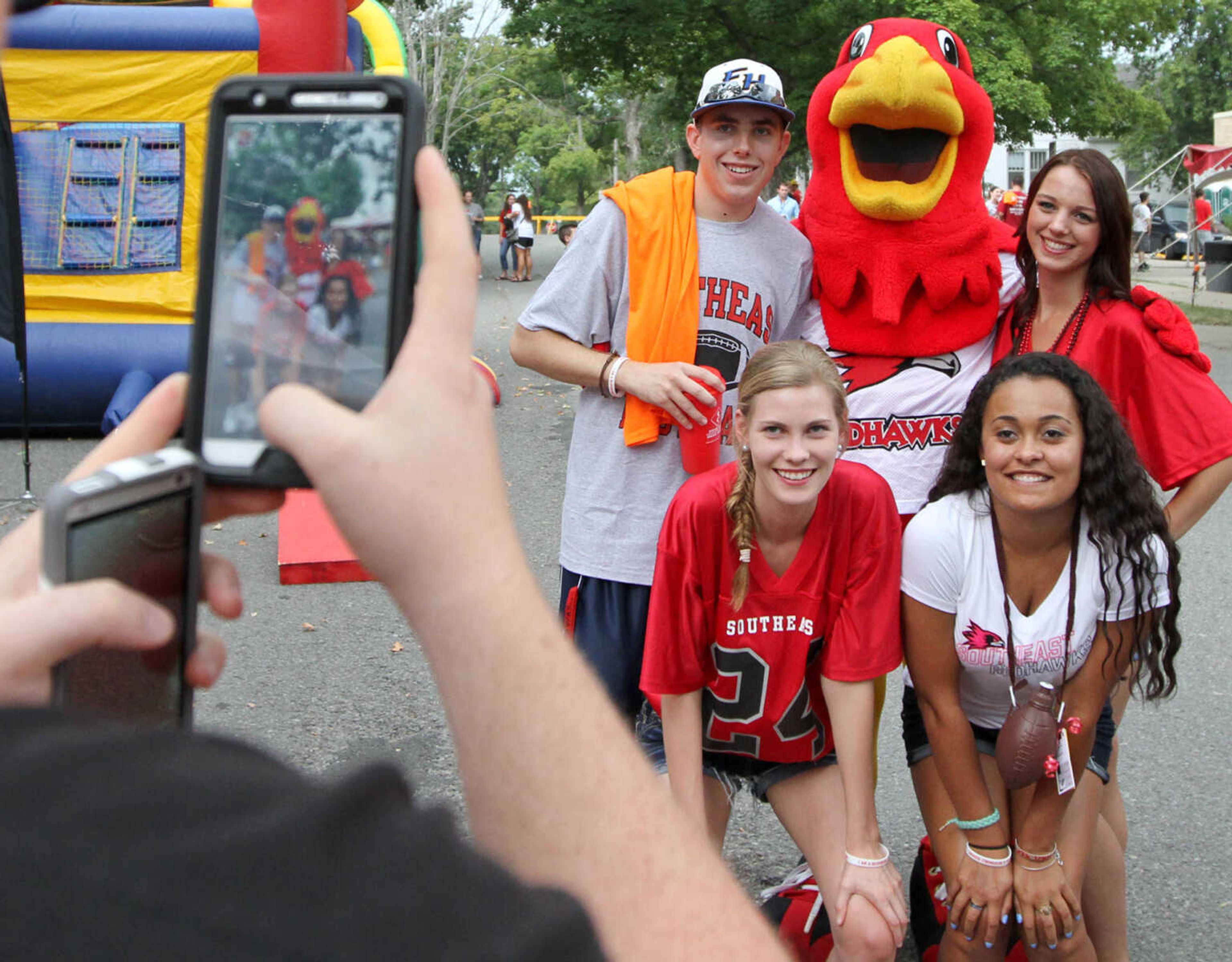 Zack Dunn uses cellphones to take photos of his friends with Rowdy the Redhawk before the Southeast Missouri State football game last season. Left to right, Stuart Shave, Mikayla Tapp, Mackenzie Porter and Leslie Koepke. (Glenn Landberg)