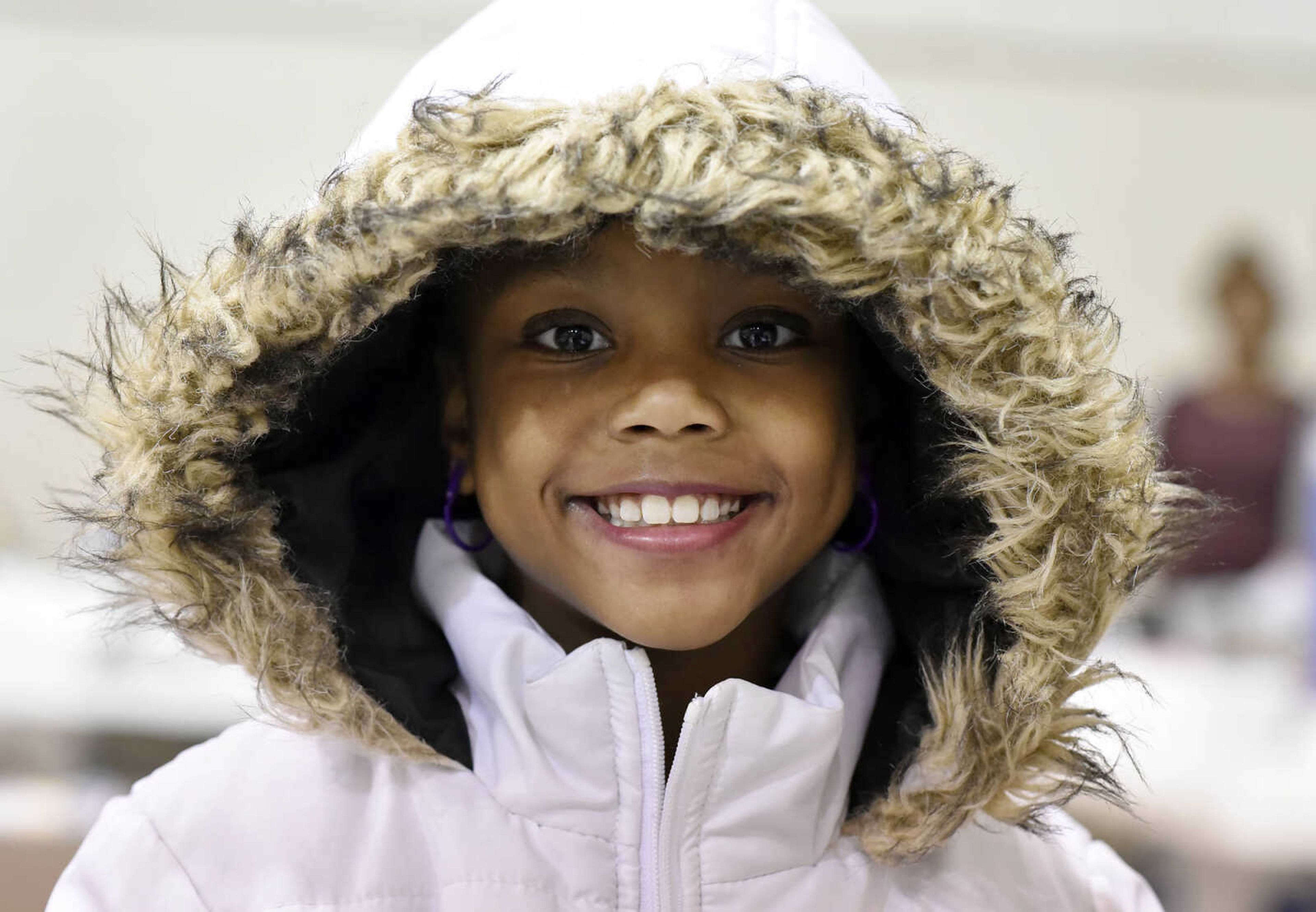 LAURA SIMON ~ lsimon@semissourian.com

Mariah Amy Oates-Cotton, 7, beams from underneath the hood of her new coat on Thursday, Nov. 24, 2016, during Thanksgiving dinner at the Salvation Army n Cape Girardeau.