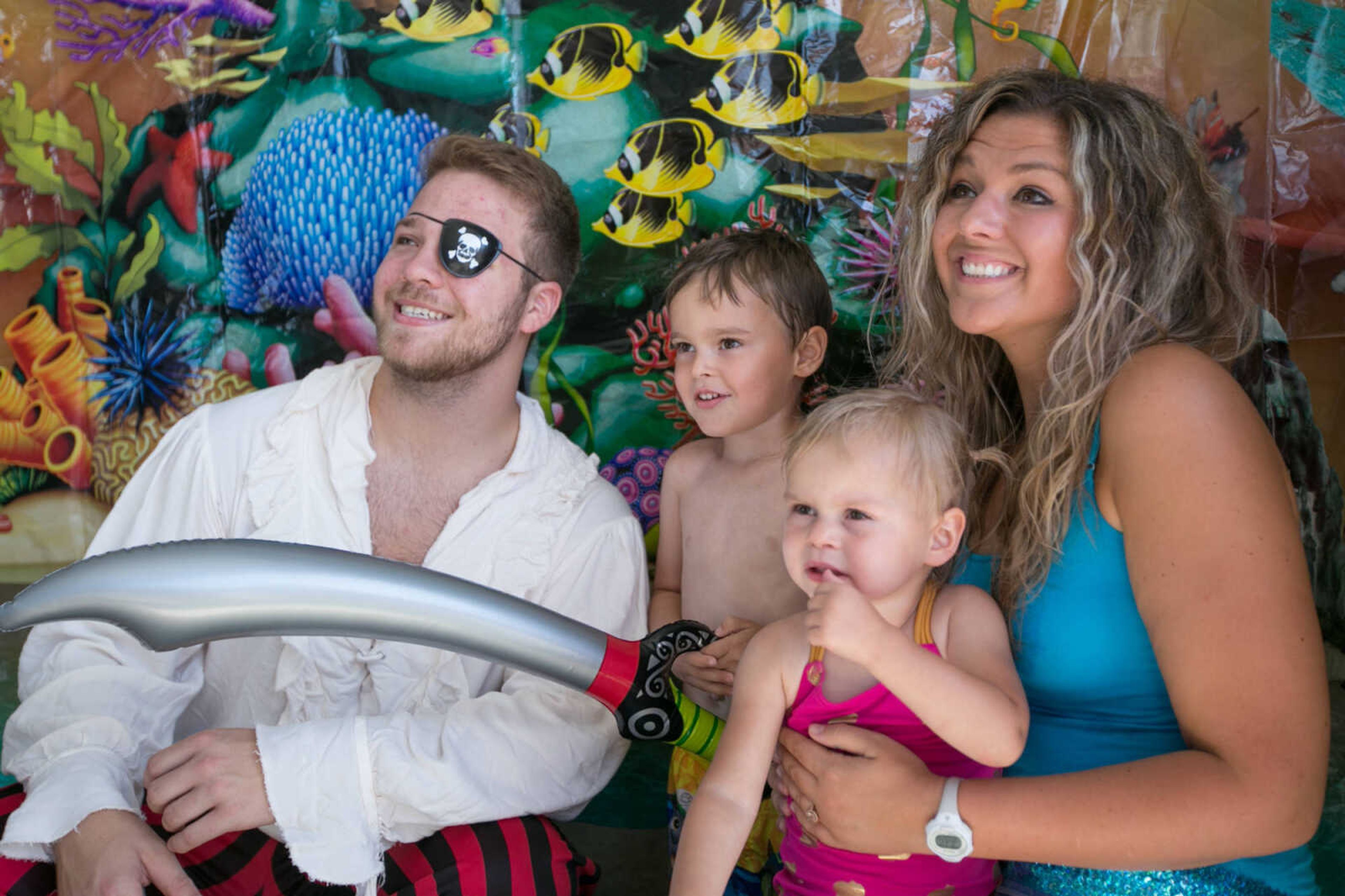 GLENN LANDBERG ~ glandberg@semissourian.com

Hudson and Brooklyn Mlot pose for a photo with Black Beard the Pirate and Ariel the Mermaid during the Mermaid and Pirate Party at Cape Splash Saturday, June 18, 2016 in Cape Girardeau.