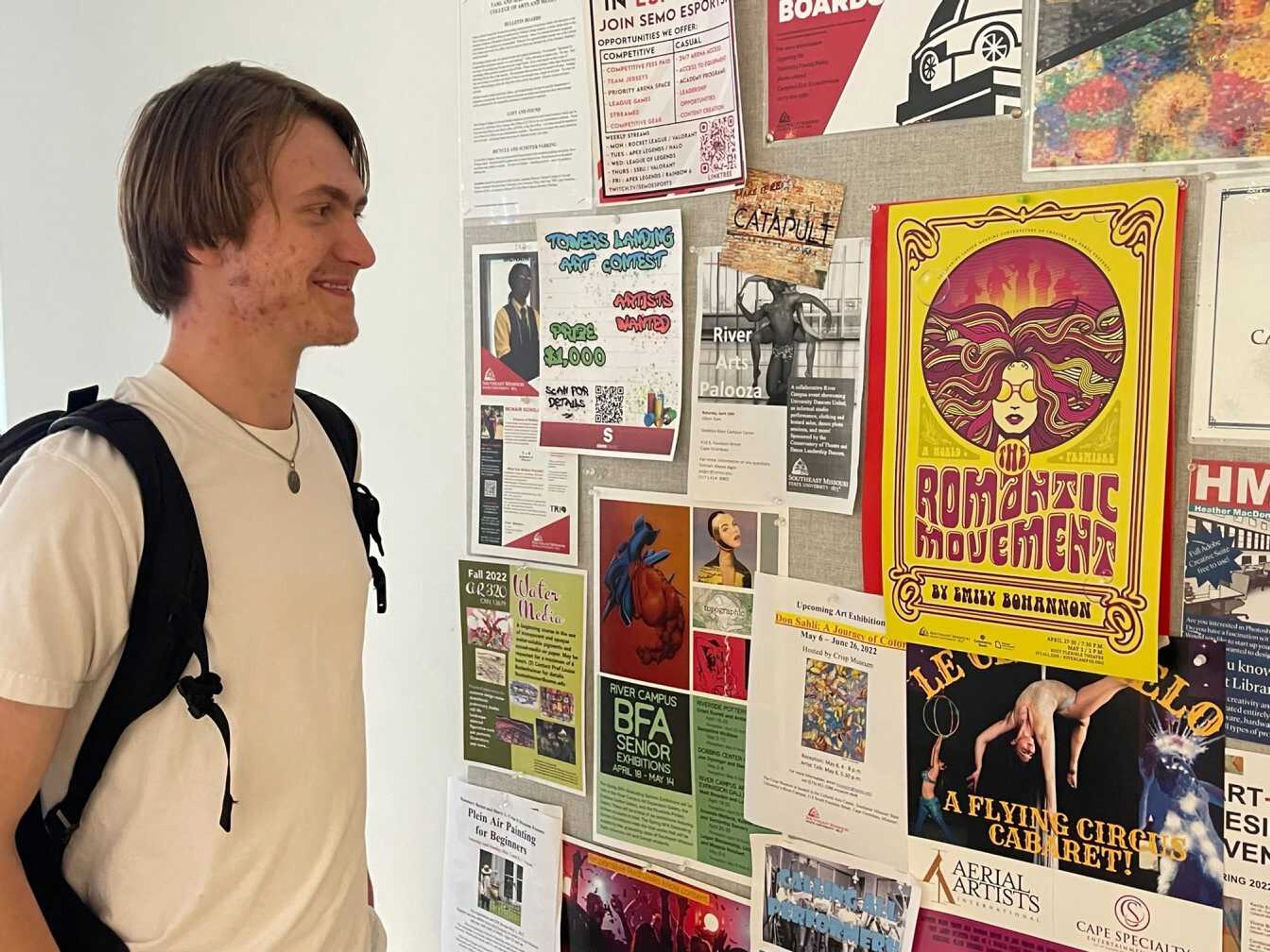 Andrew Signaigo, a music composition student at Southeast Missouri State University, reads a poster for this week's performances of "The Romantic Movement" at the university's River Campus. Performances continue at 7:30 p.m. today and Saturday and 2 p.m. Sunday in Rust Flexible Theatre.