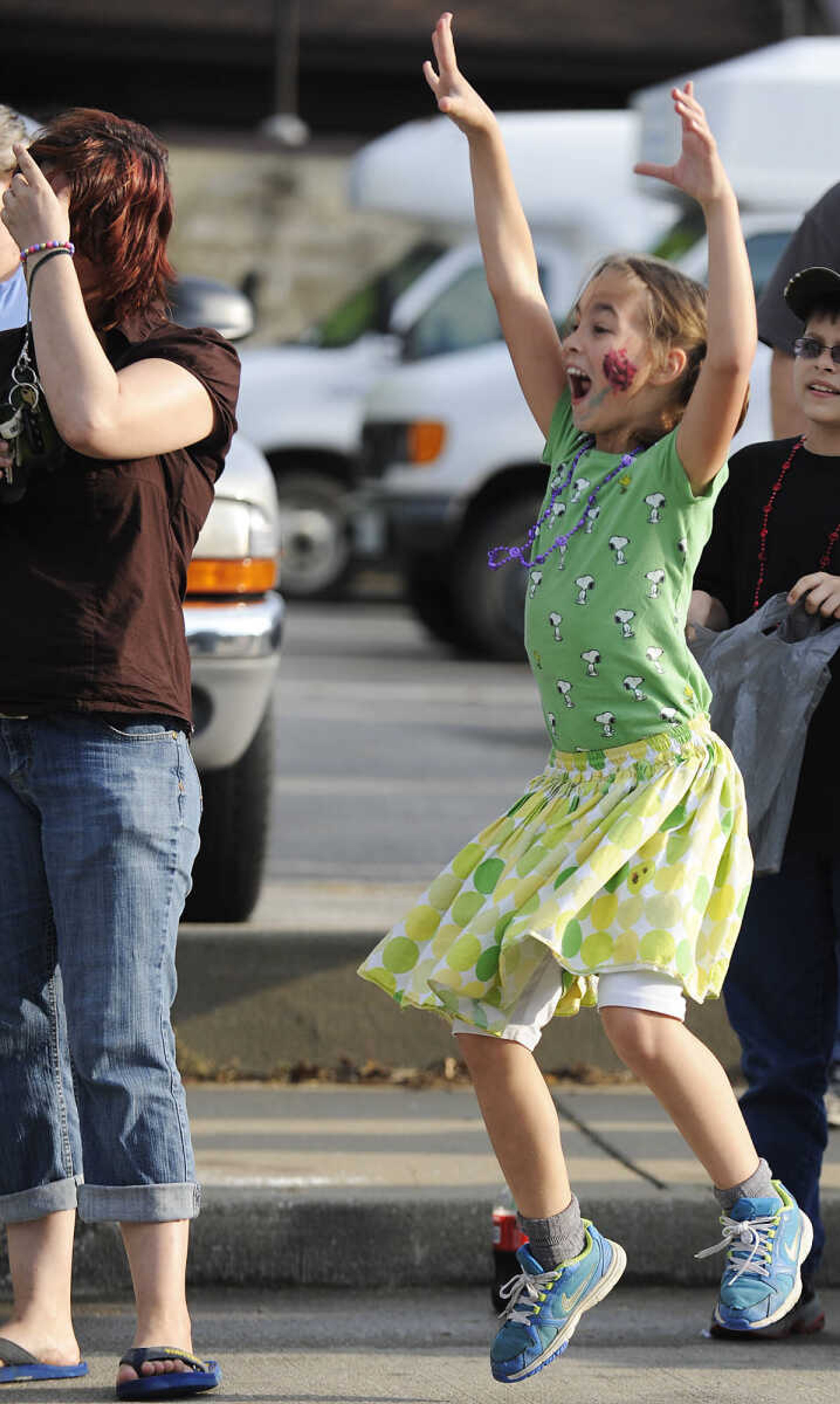 Kamea Foster, 9, leaps into the air trying to attract the attention of people throwing candy during the Perryville Mayfest Parade Friday, May 10, in Perryville, Mo. This year's Mayfest theme is Peace, Love, Perryville Mayfest.