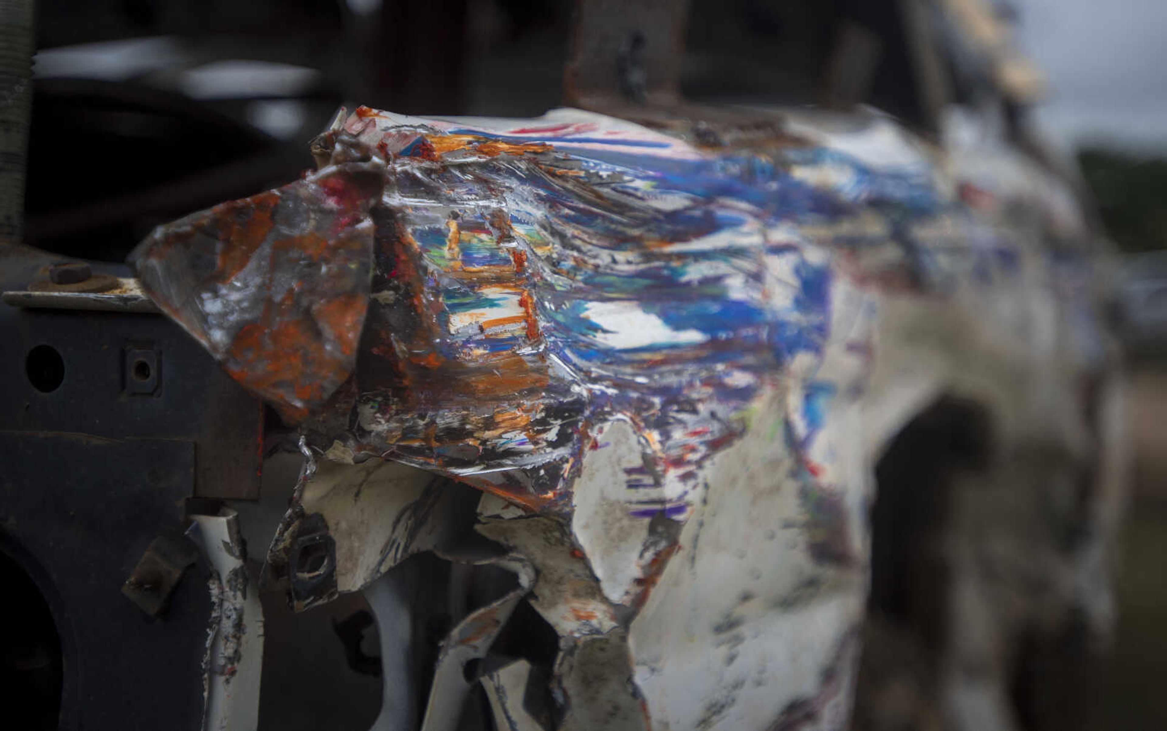 A rainbow of scraped paint is seen on the leading edge of a once-white car after the SEMO District Fair demolition derby Sunday.