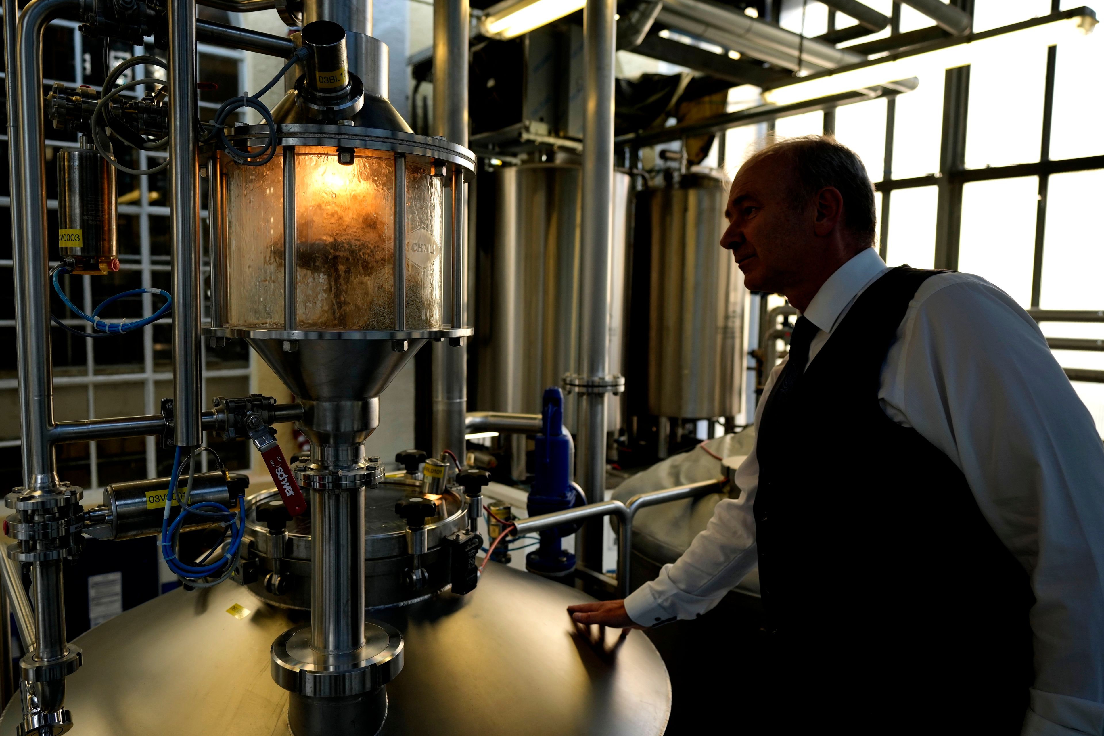 Professor Thomas Becker checks the brewery plant in Freising, Germany, Thursday, Sept. 19, 2024. (AP Photo/Matthias Schrader)