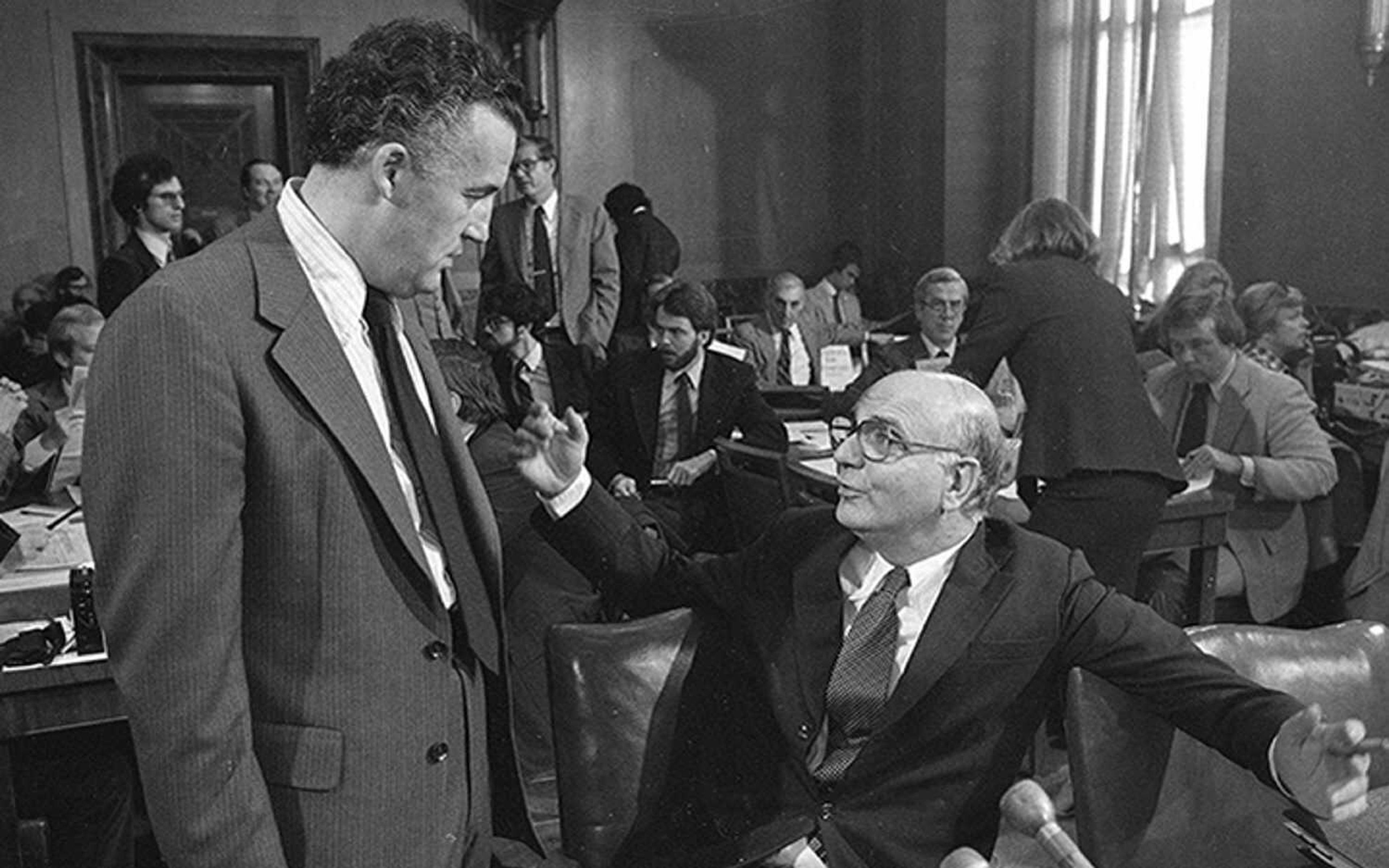 Paul Volcker, seated, former chair of the Federal Reserve Board, is seen prior to an appearance before the Senate Banking Committee in 1979 in Washington, D.C.