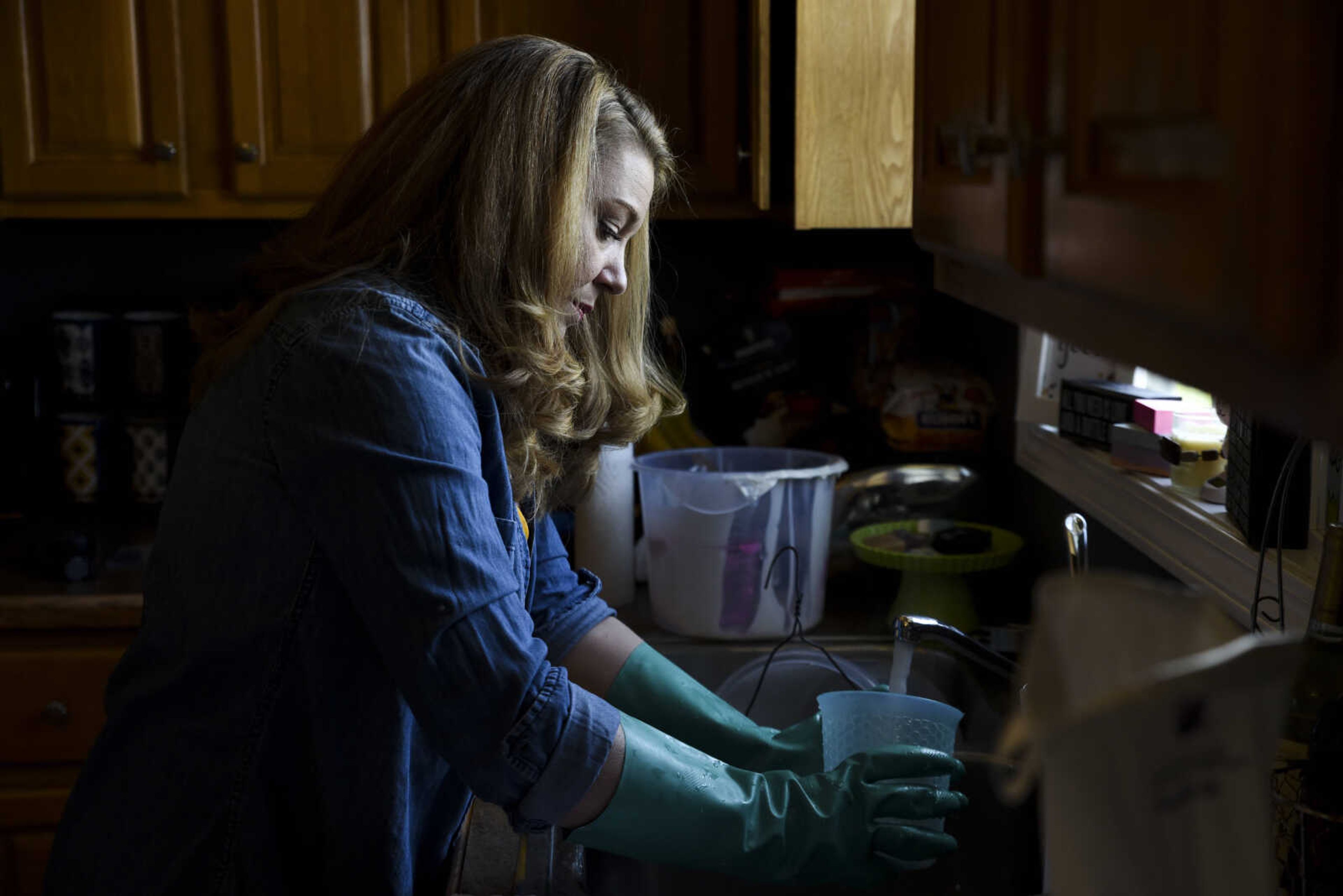 Breanna Stone washes materials used as part of her soap-making process in her home Tuesday, May 1, 2018, in Jackson.