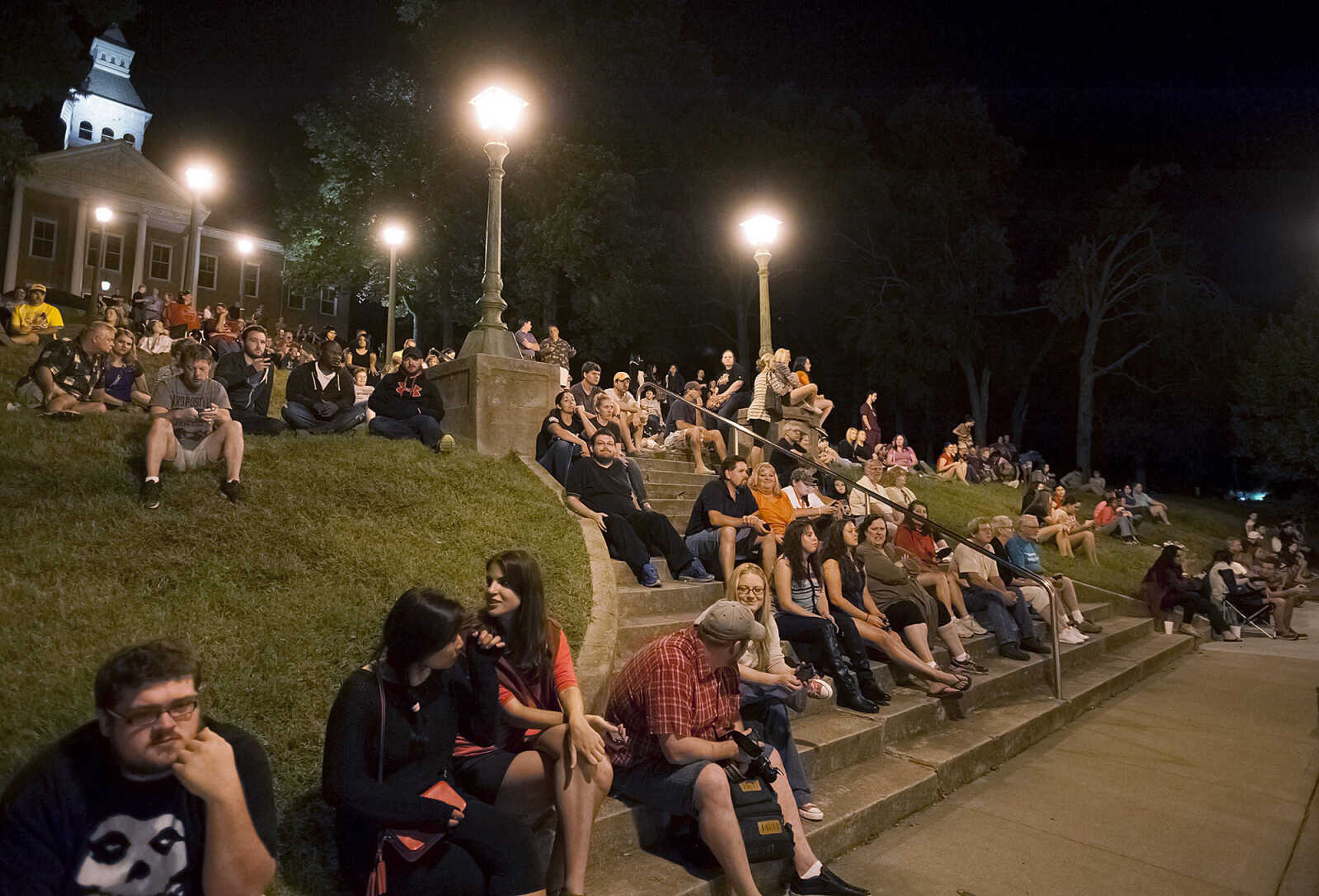 Spectators wait on the steps of the Common Pleas Courthouse for filming to begin on a scene for the 20th Century Fox feature film "Gone Girl," Friday, Sept. 27, in downtown Cape Girardeau. Directed by David Fincher and staring Ben Affleck and Rosamund Pike the film is expected to be filming in the Cape Girardeau area for several weeks.