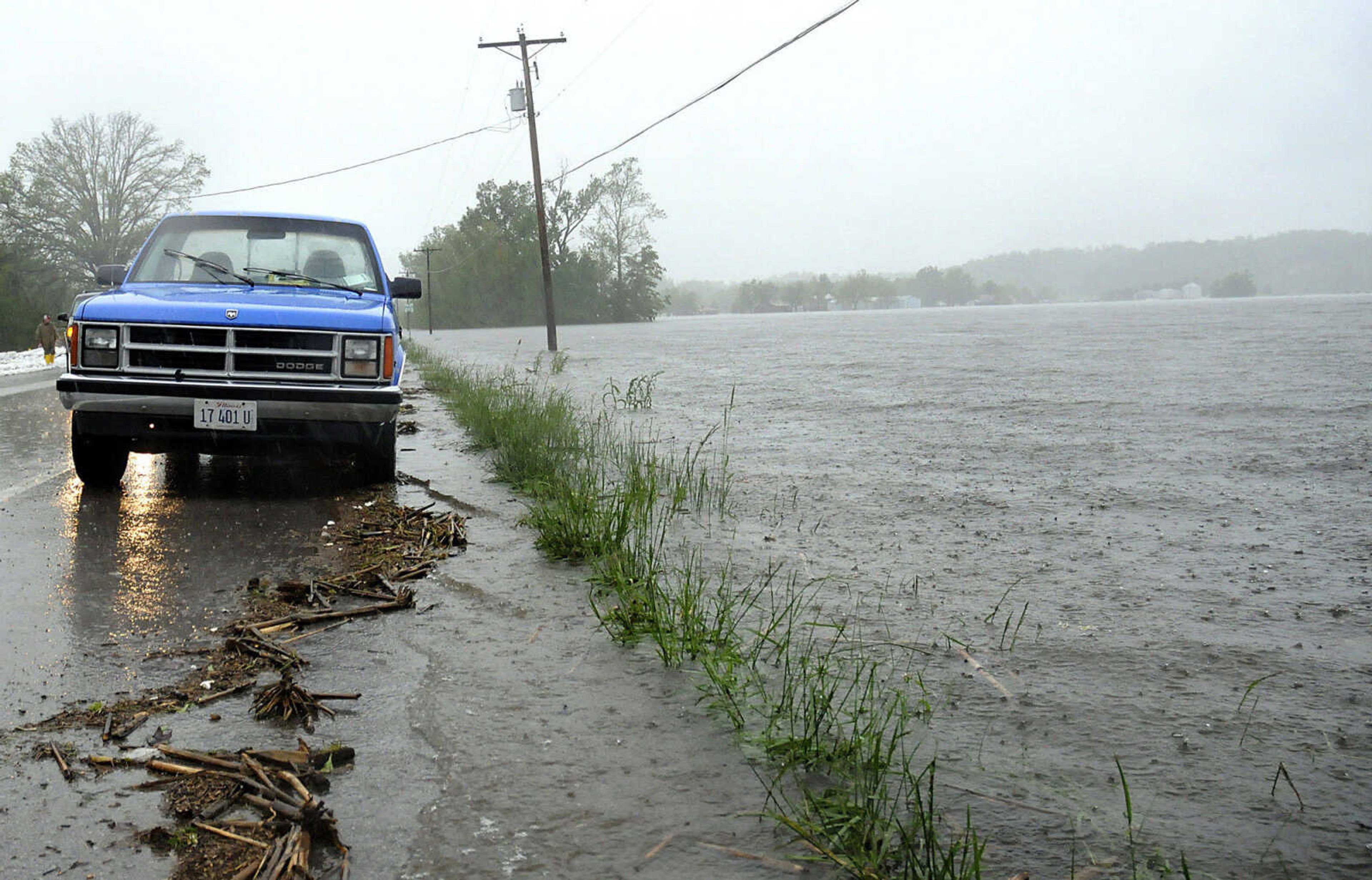 Floodwaters creep towards Illinois 3 on Sunday, May 1, 2011 in Olive Branch, Ill. Volunteers were scrambling to build a sandbag wall to protect homes on the opposite side of the highway. (AP Photo/The Southern Illinoisan, Alan Rogers)