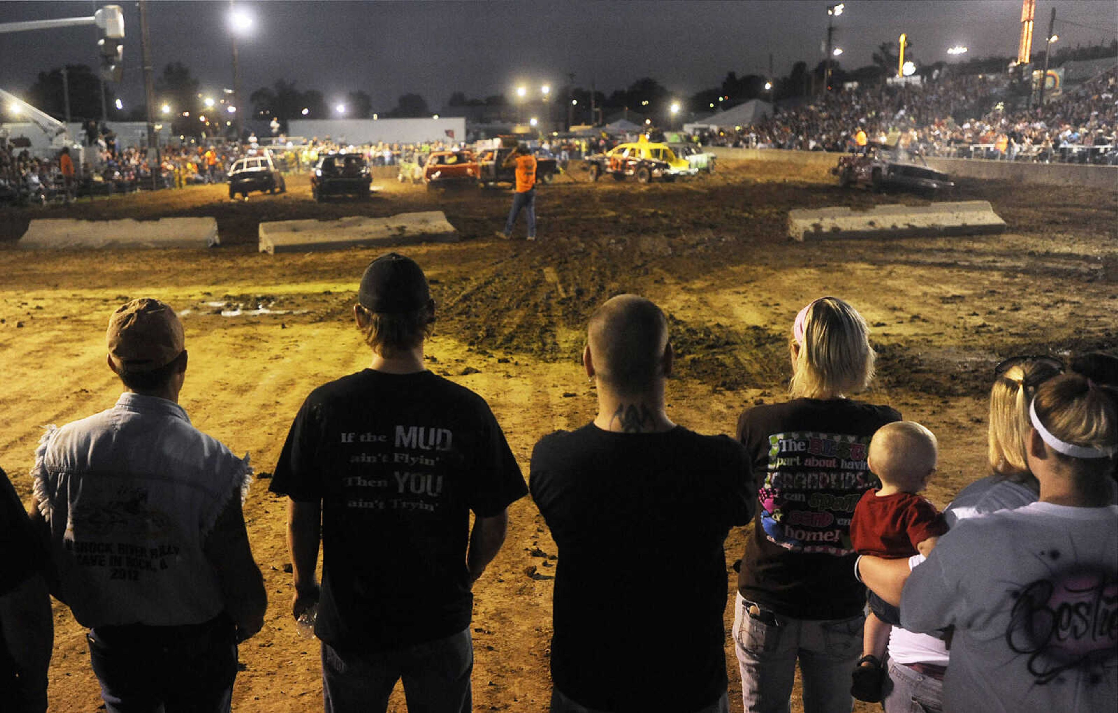 Spectators watch the Dual Demo Derby at the SEMO District Fair Tuesday, September 11, at Arena Park in Cape Girardeau. 
.